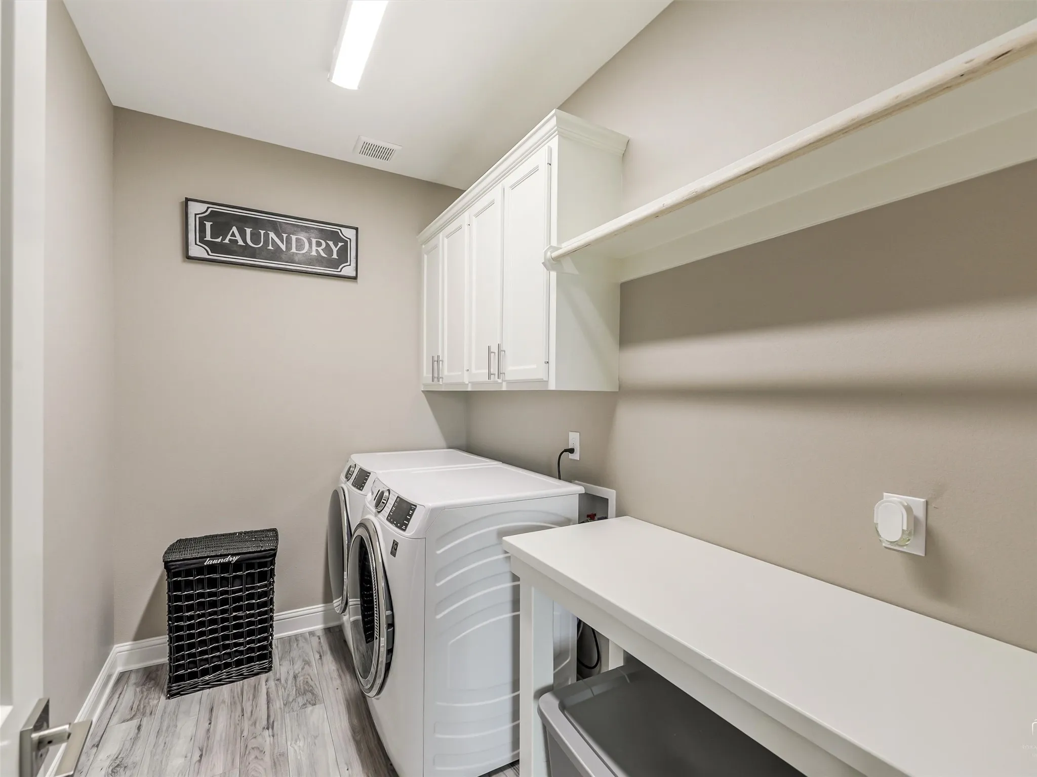Large walk in laundry room with cabinetry and ample room for organization, storage and more.