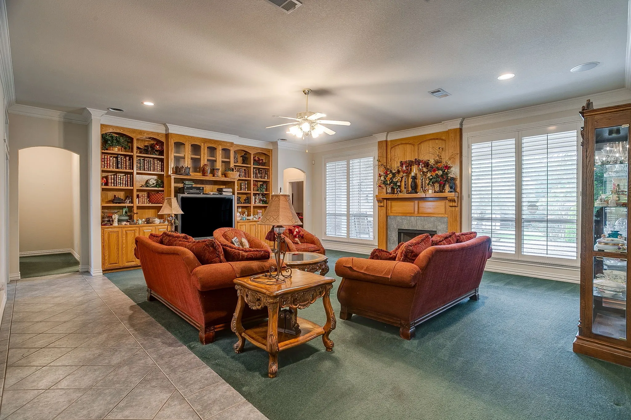 Living room downstairs with fireplace & built-ins.