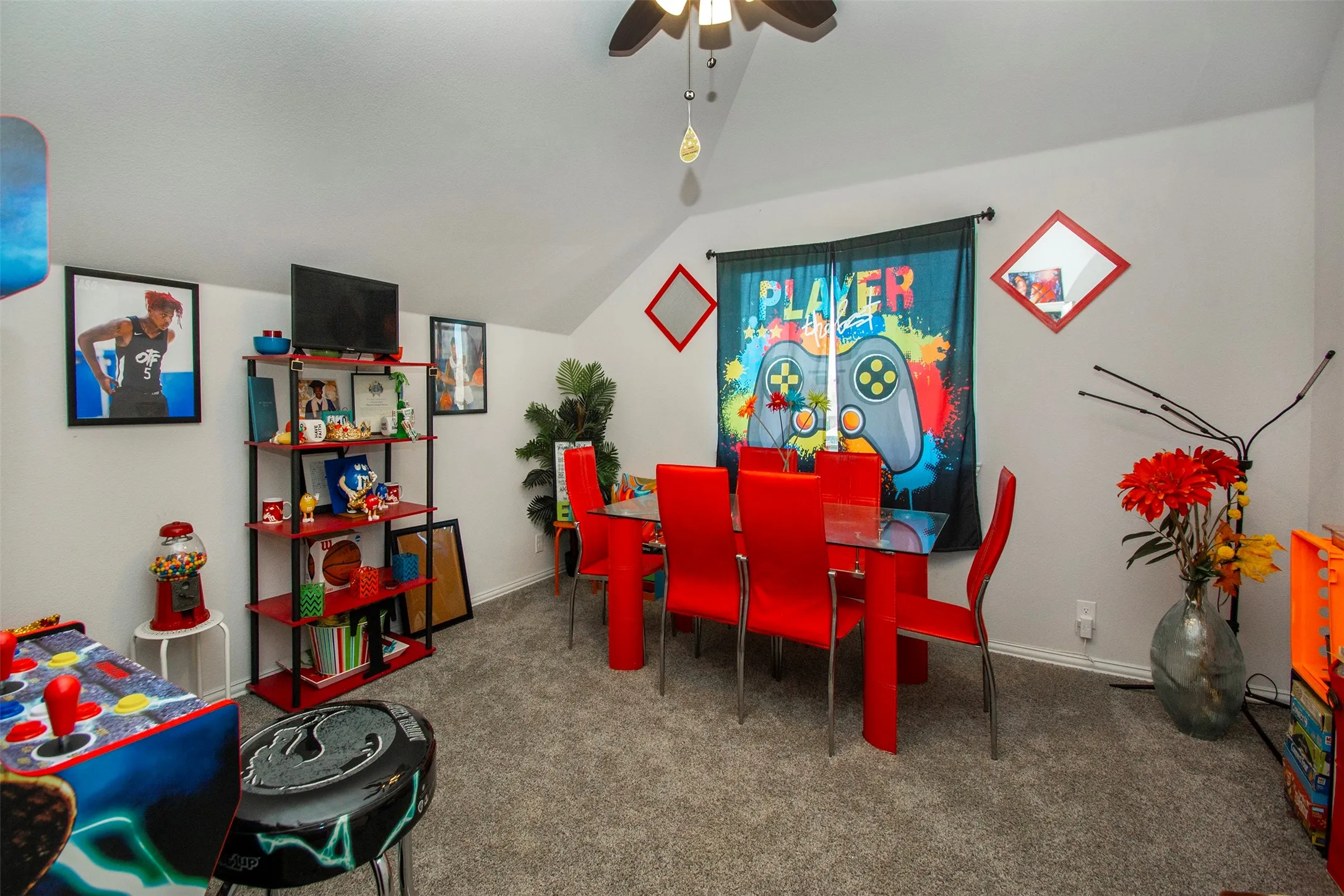 Carpeted room featuring a sloped ceiling, ceiling fan, and white walls