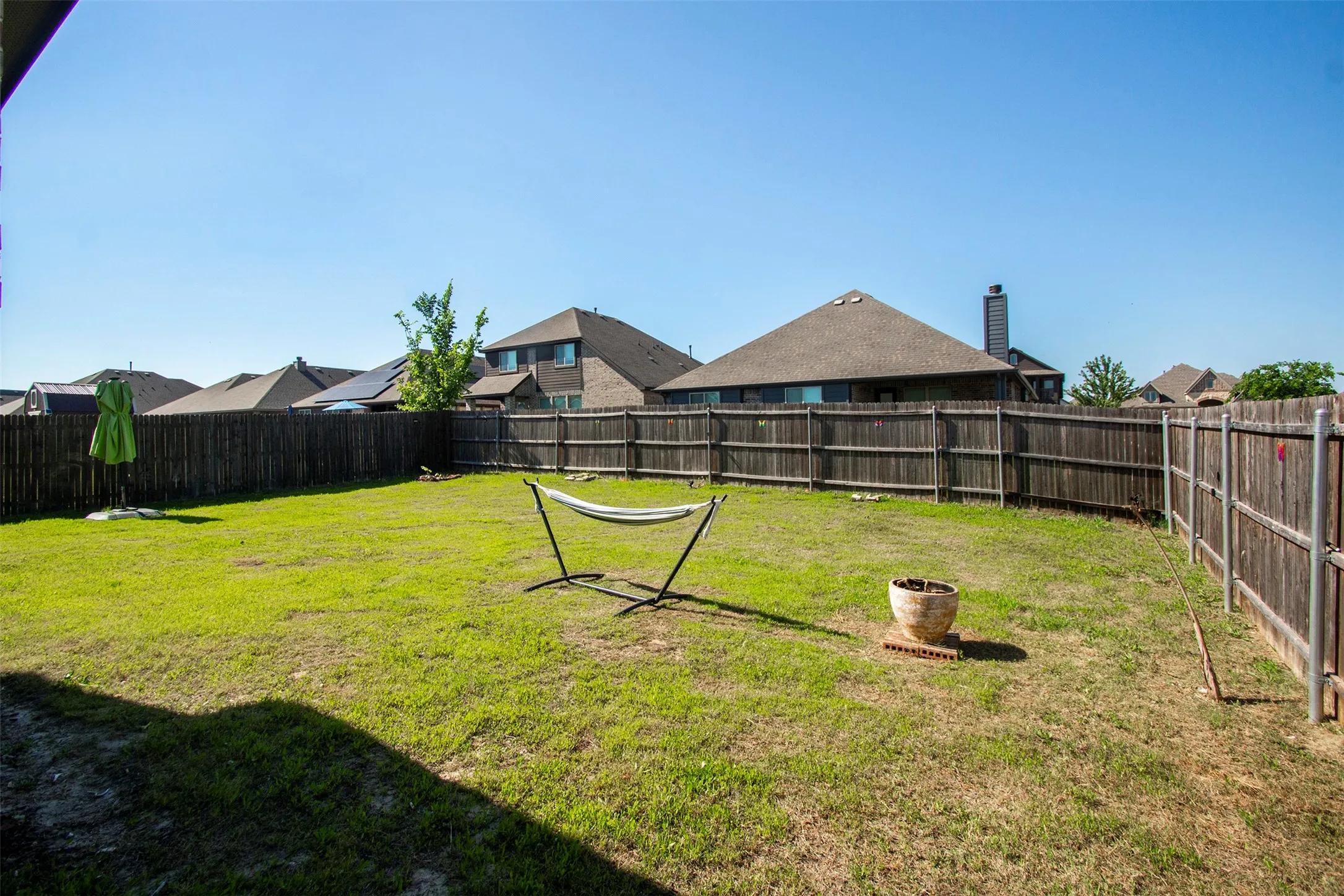 Spacious backyard featuring a wood privacy fence and a broad expanse of grass