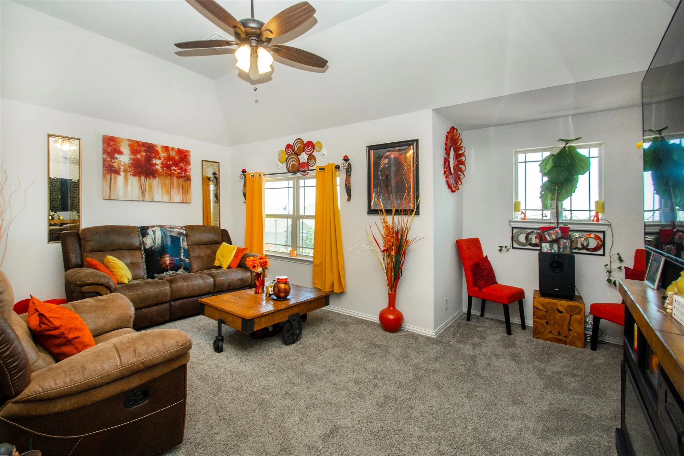 Living area featuring vaulted ceilings, recessed lighting, and light gray carpeting