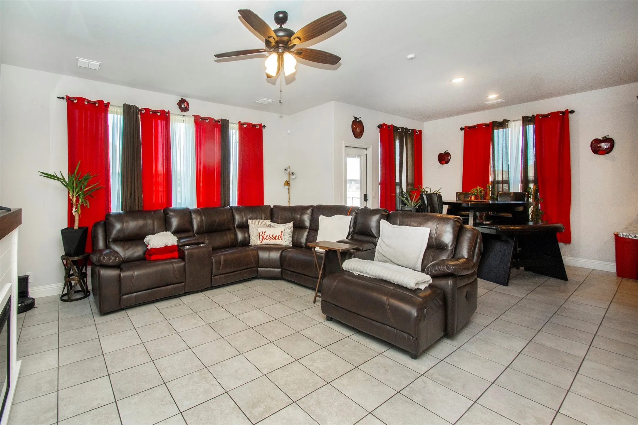Open-concept living space with light-toned tile flooring throughout