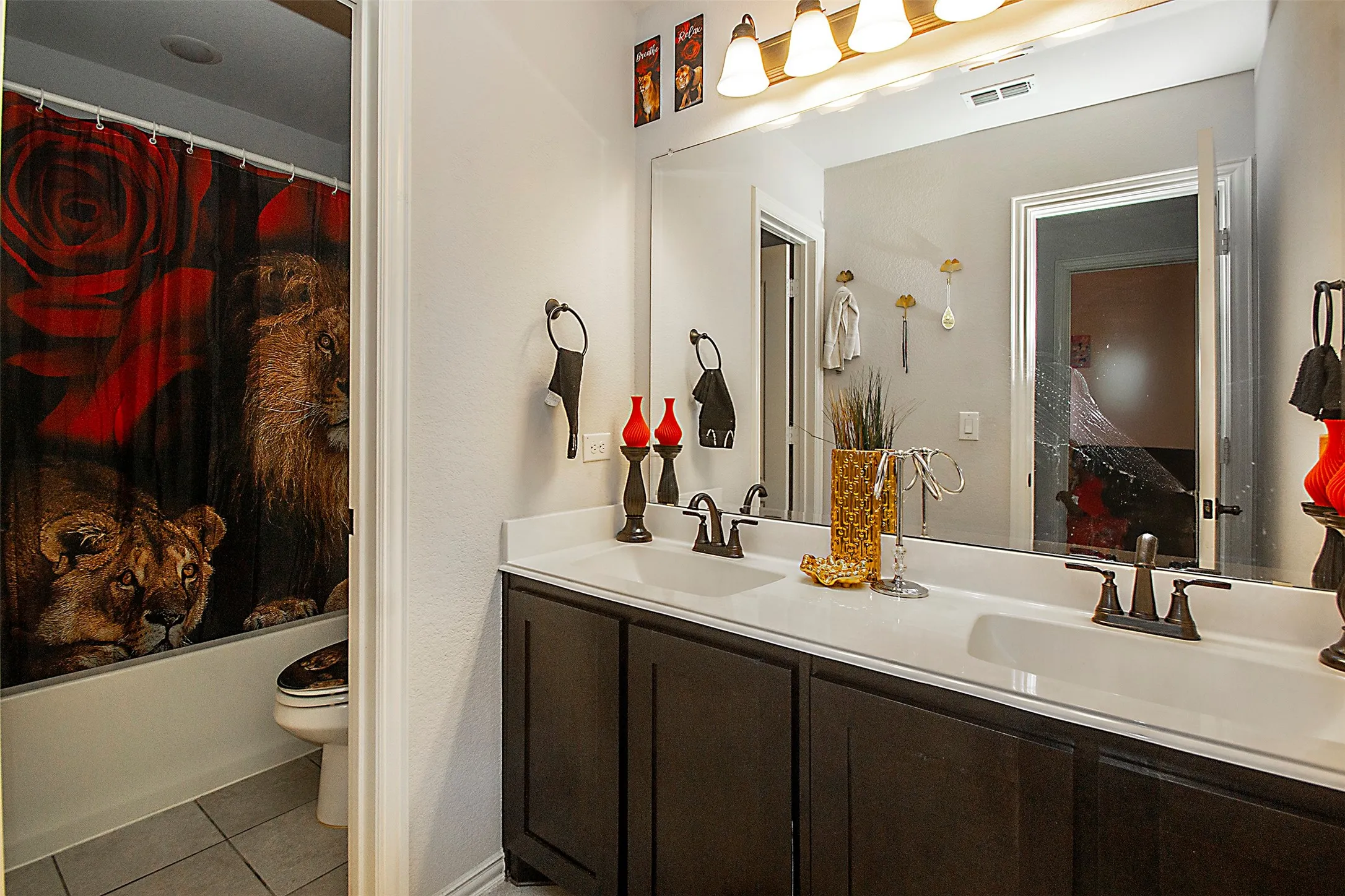 Dual vanity with white countertop, integrated sinks, and dark wood cabinetry