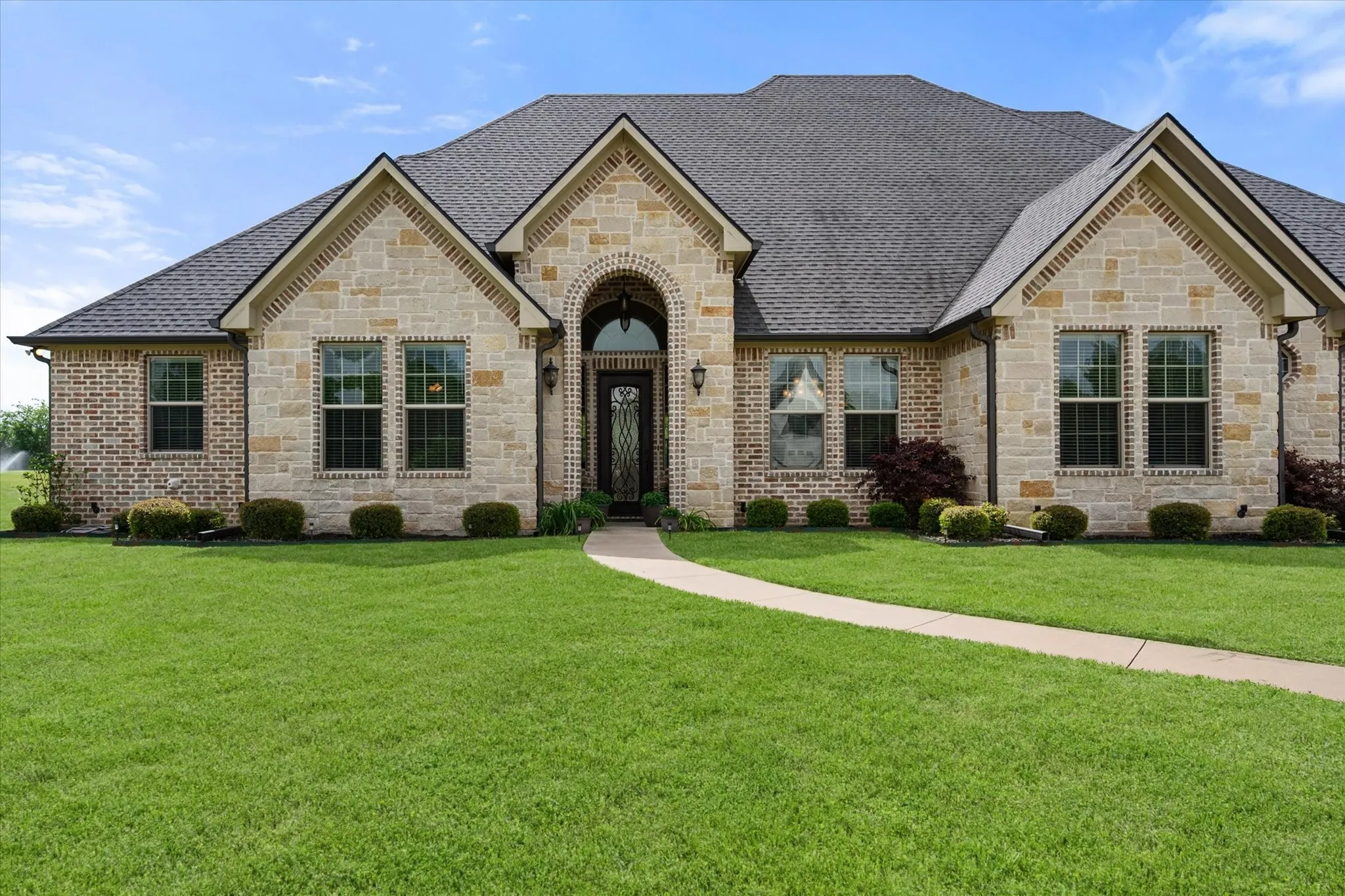 Traditional-style exterior with a combination of light-colored stone and brick facades