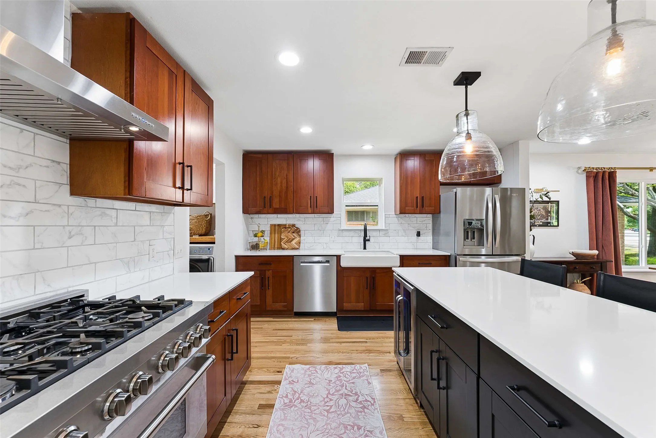 Zline range. Quartz counters. Mini fridge built into island. Farmhouse sink