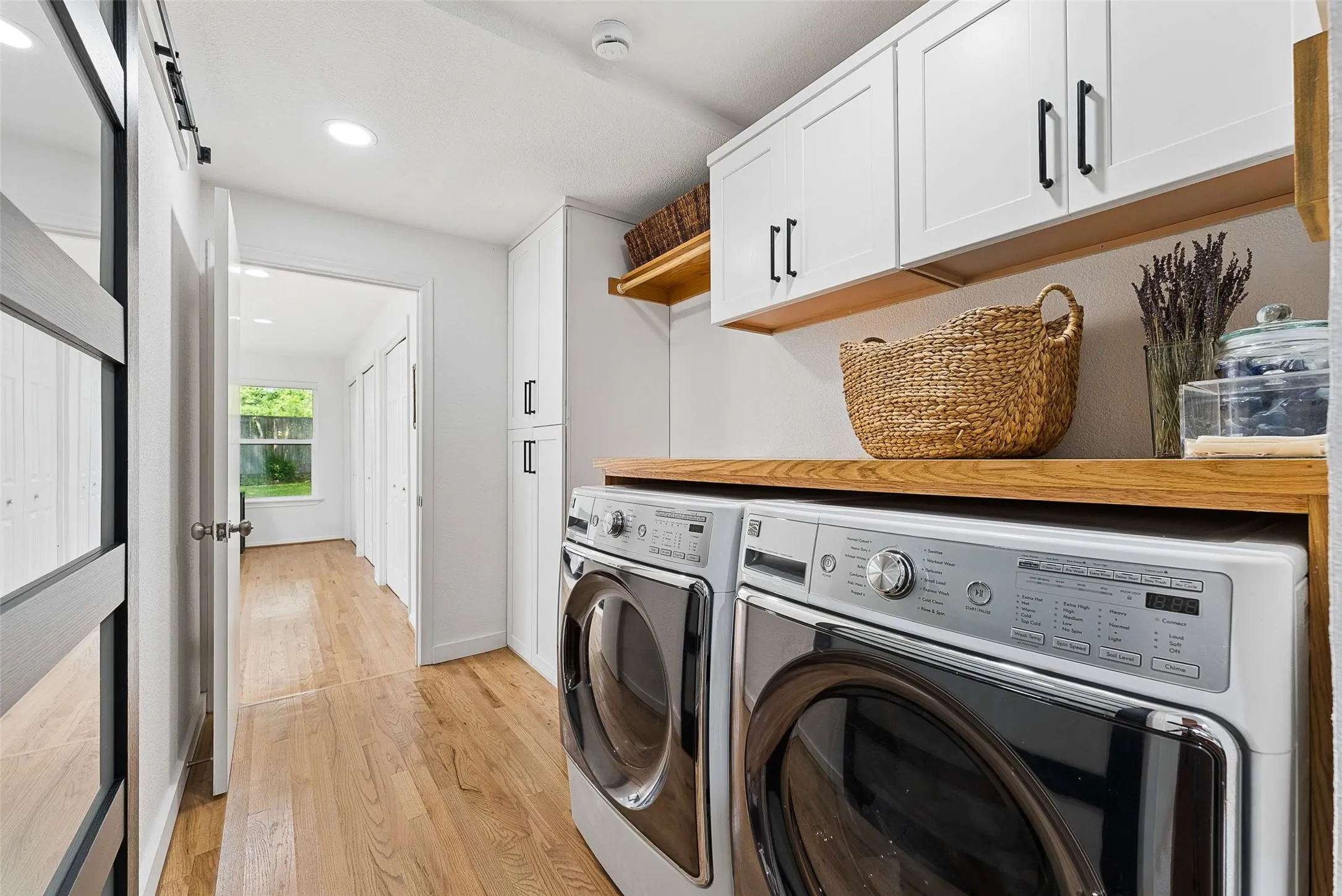 Laundry room with built in counters. Pantry to the left.