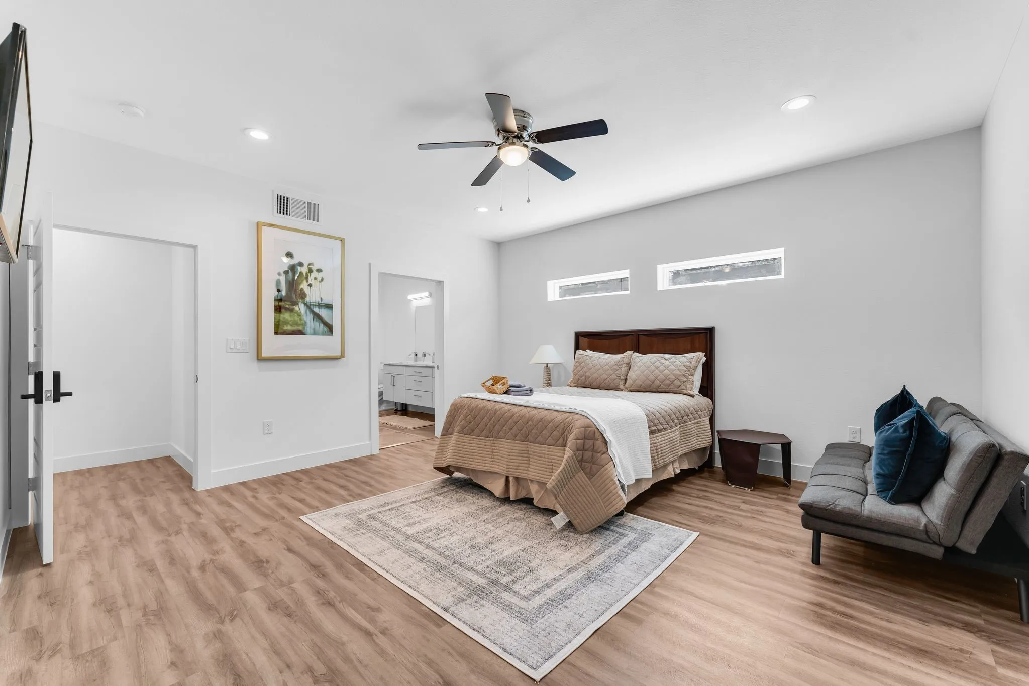 This room features light wood-style flooring, a ceiling fan, and recessed lighting
