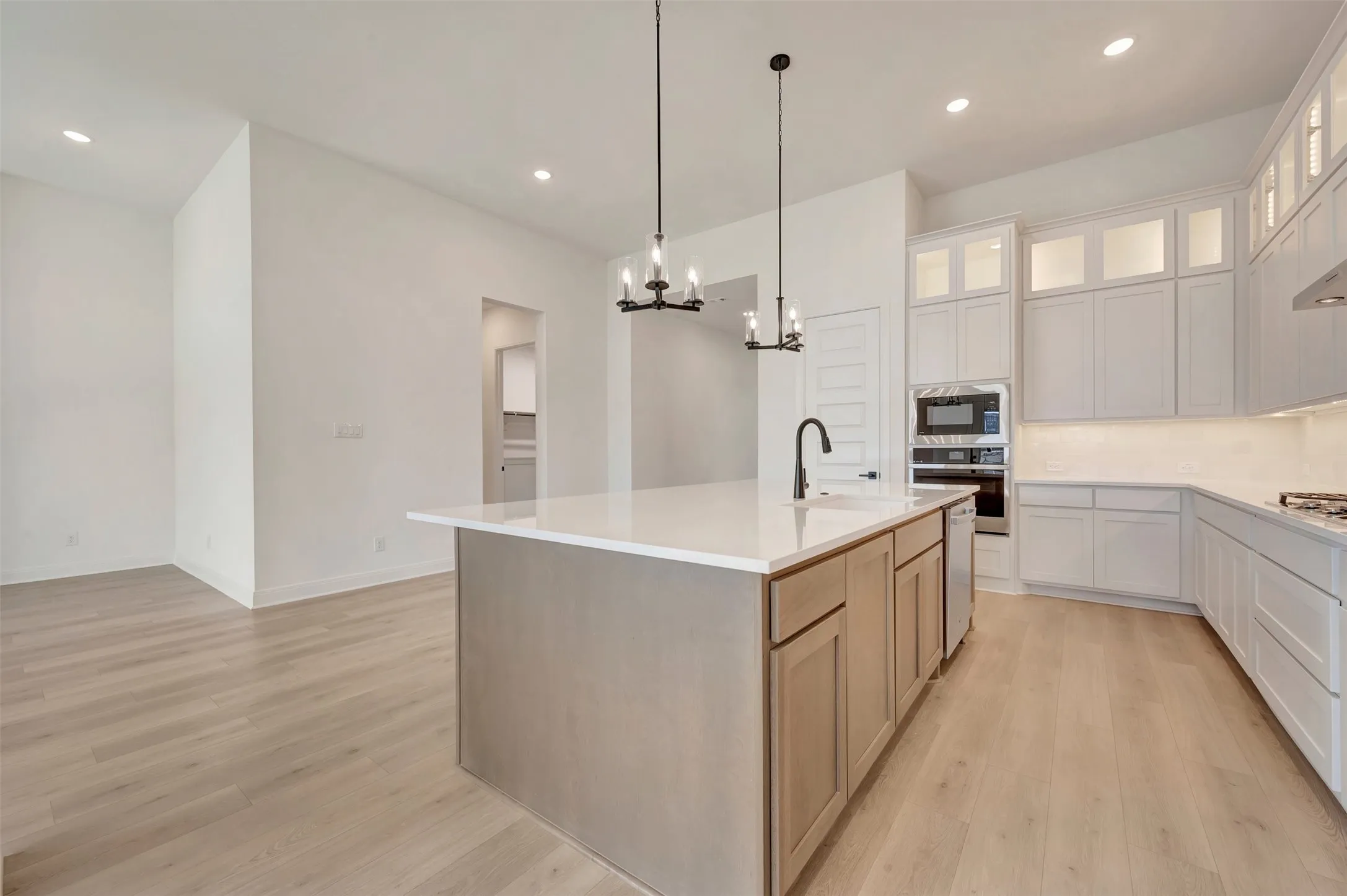 Expansive kitchen island featuring a deep undermount sink and matte black faucet