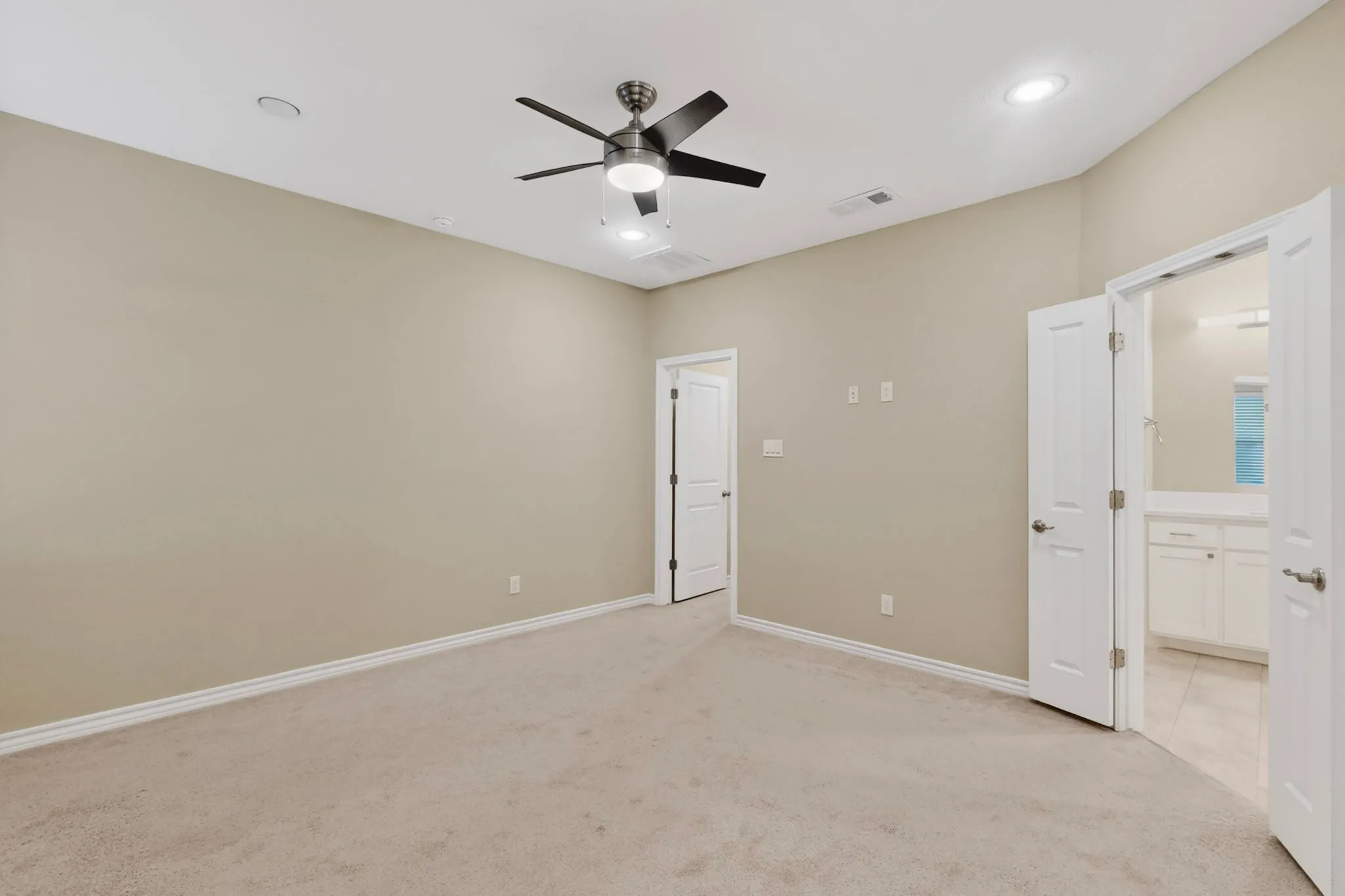 Carpeted room featuring a ceiling fan with integrated lighting, recessed lighting, and a neutral wall color