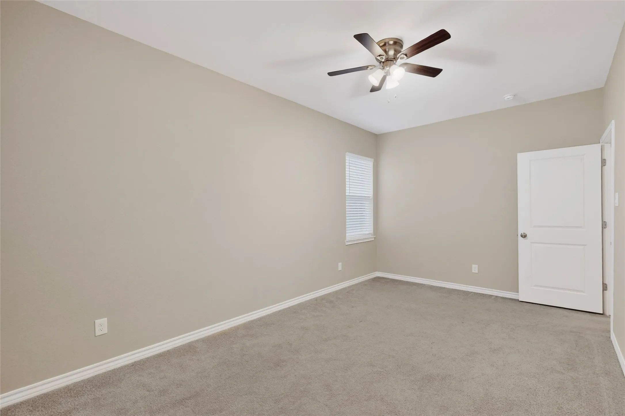 Bedroom featuring neutral-toned walls, gray carpet flooring, and white baseboards