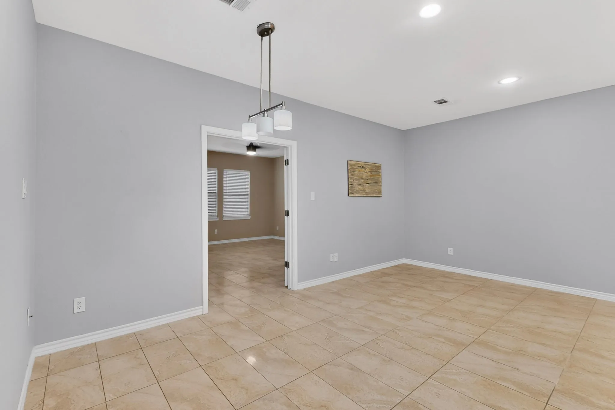 Neutral-toned tile flooring throughout an open concept area