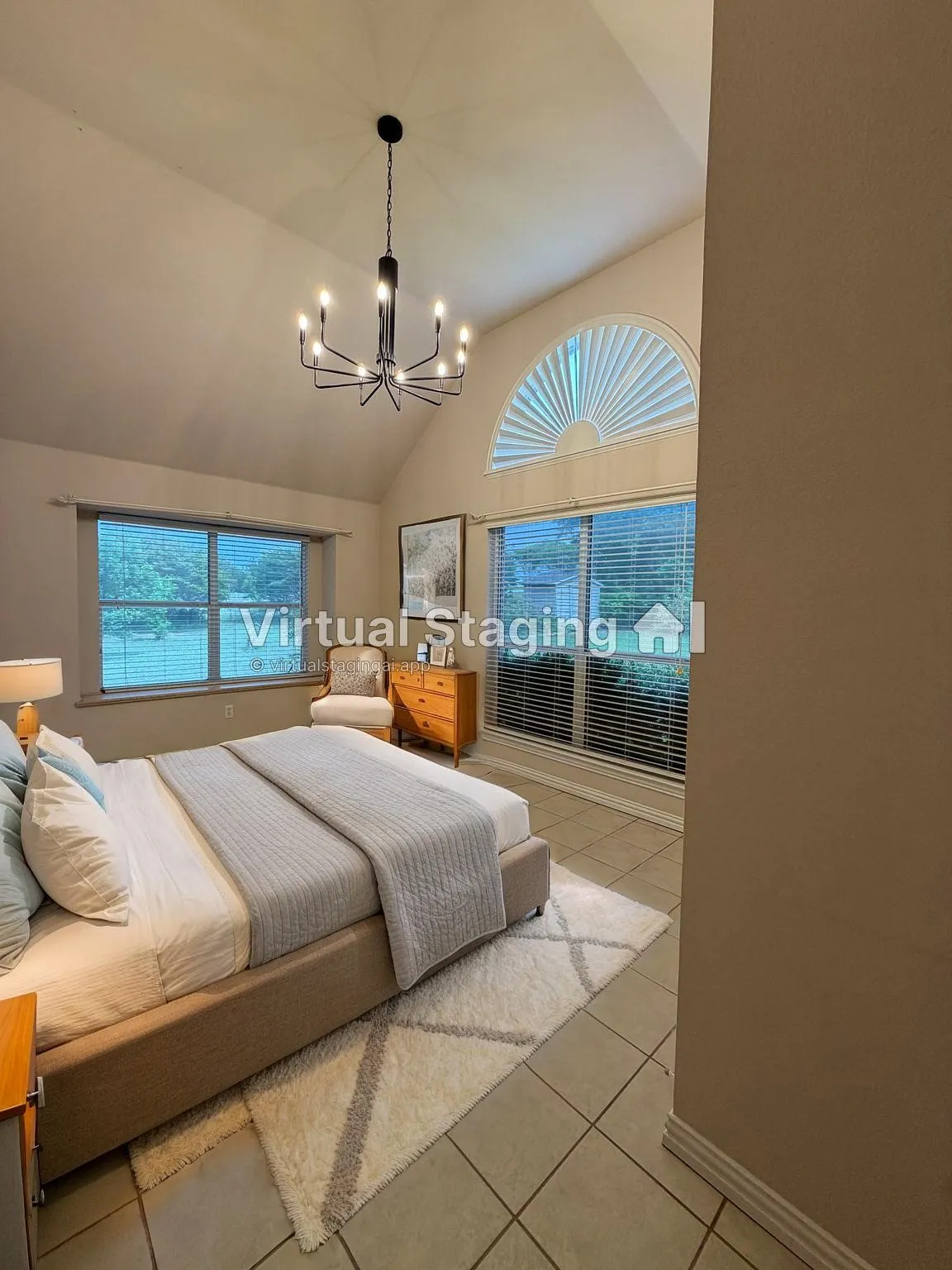 Vaulted ceiling featuring a contemporary chandelier, arched window with horizontal blinds, and tile flooring