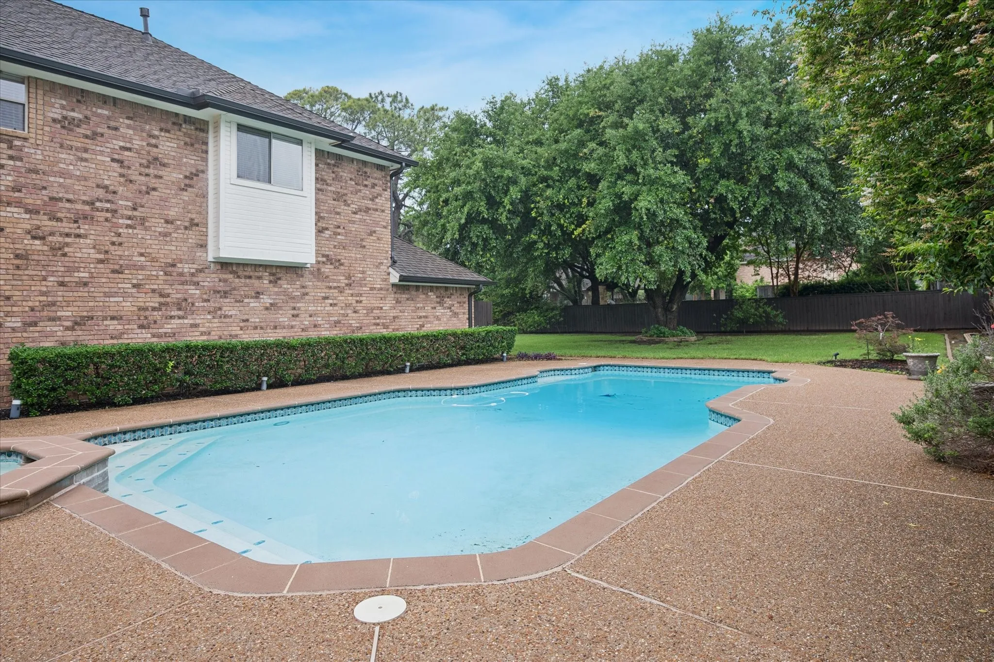Large backyard beyond the pool