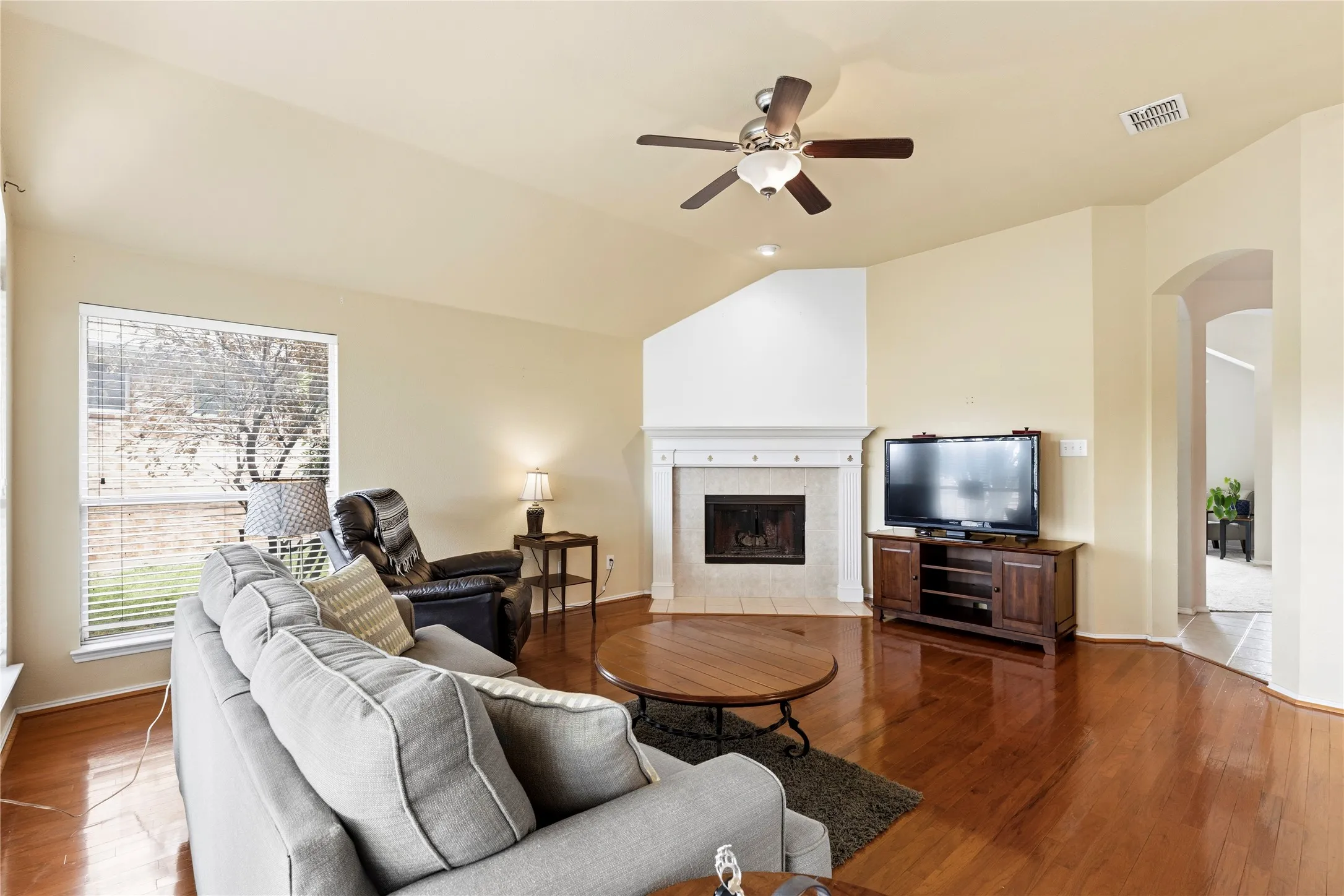 Living room with cozy wood-burning fireplace.