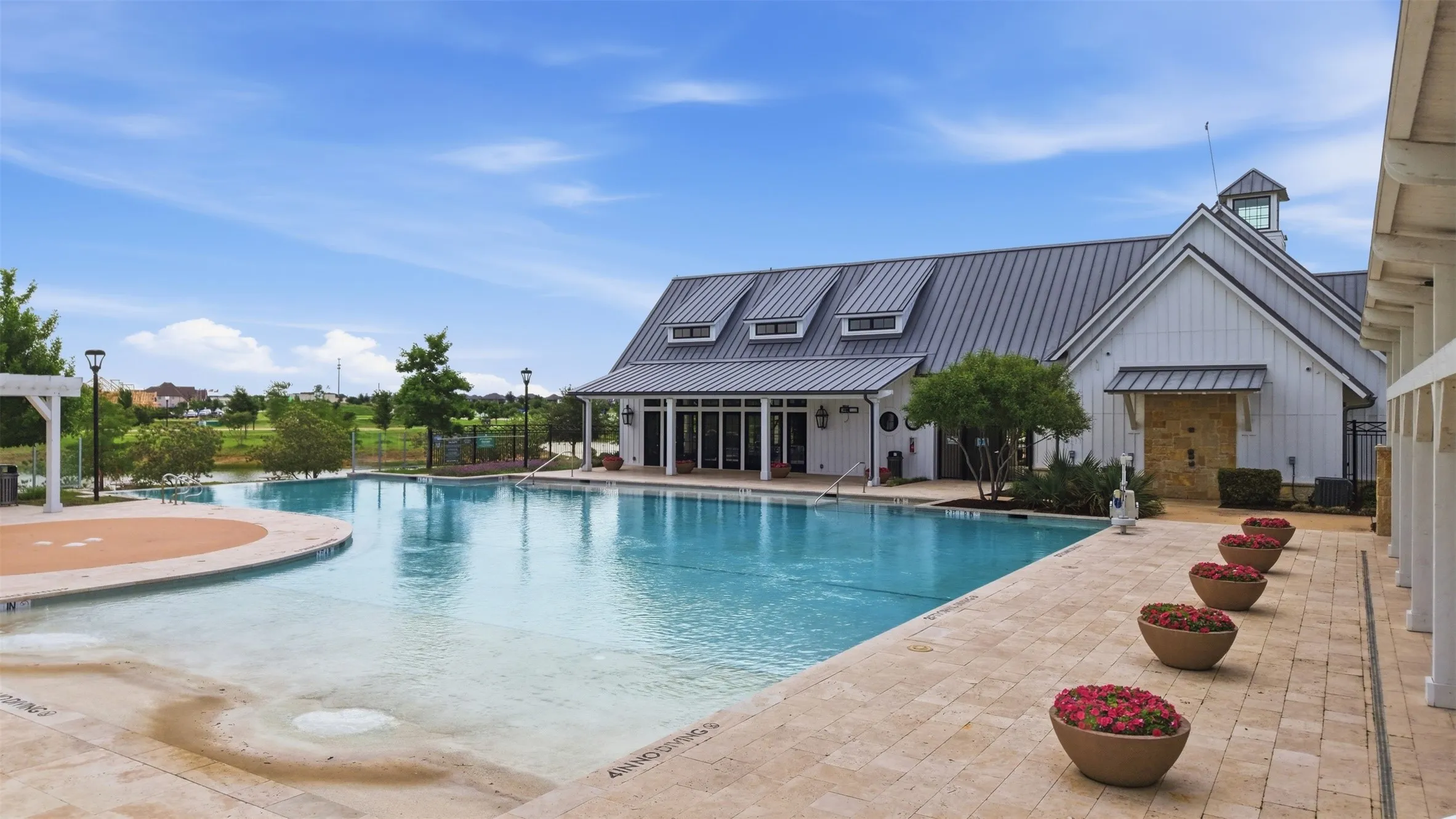 Resort-style pool with a broad sun shelf and integrated spa