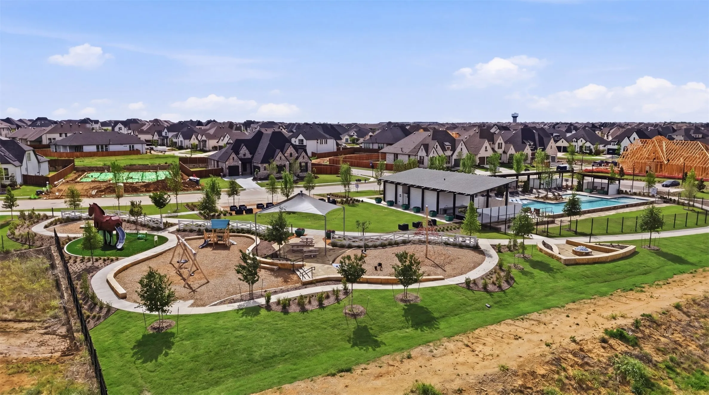 Community park area featuring a swimming pool, covered pavilion, and dedicated playground spaces