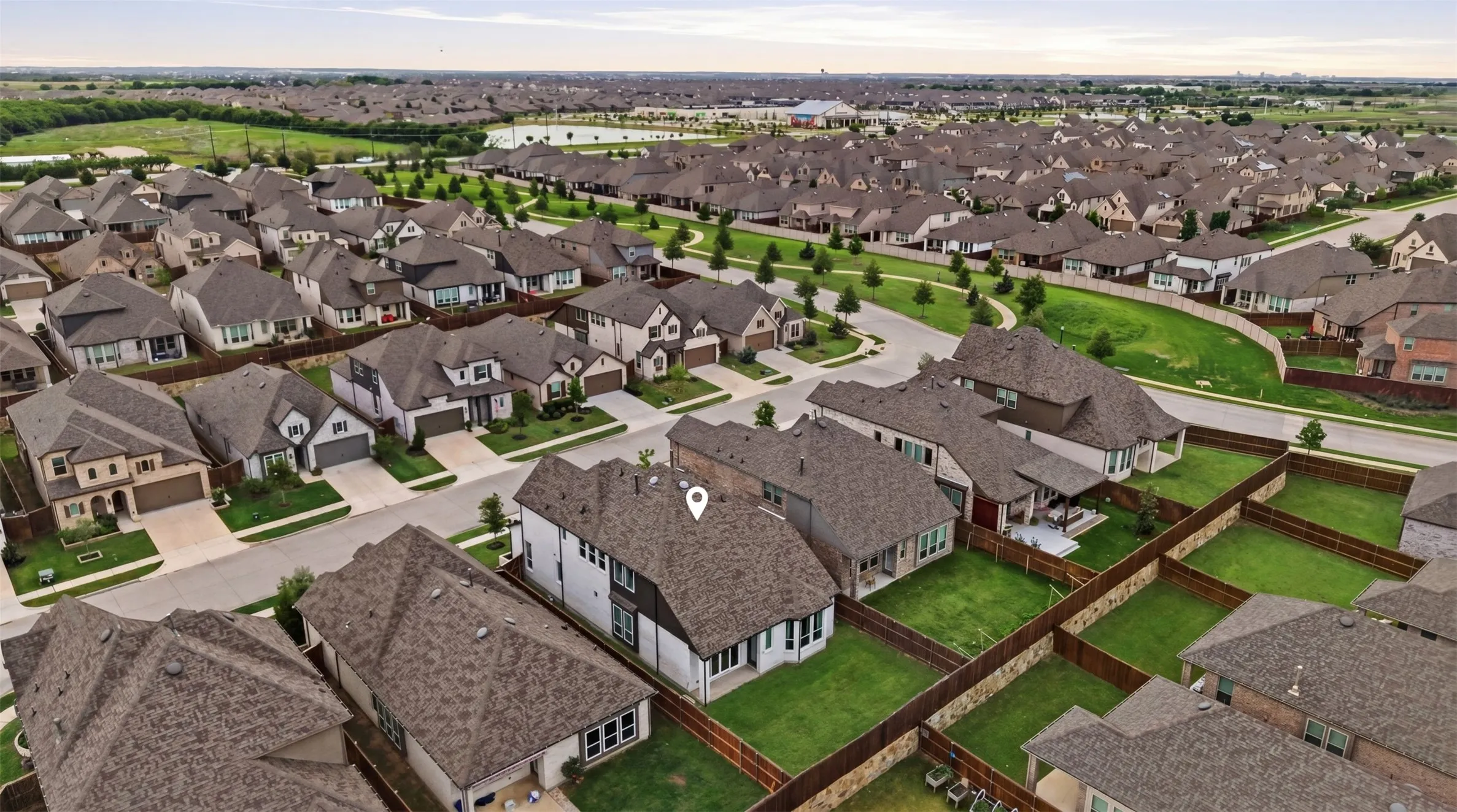 Expansive neighborhood featuring numerous residential properties with diverse architectural styles, fenced backyards, and mature landscaping