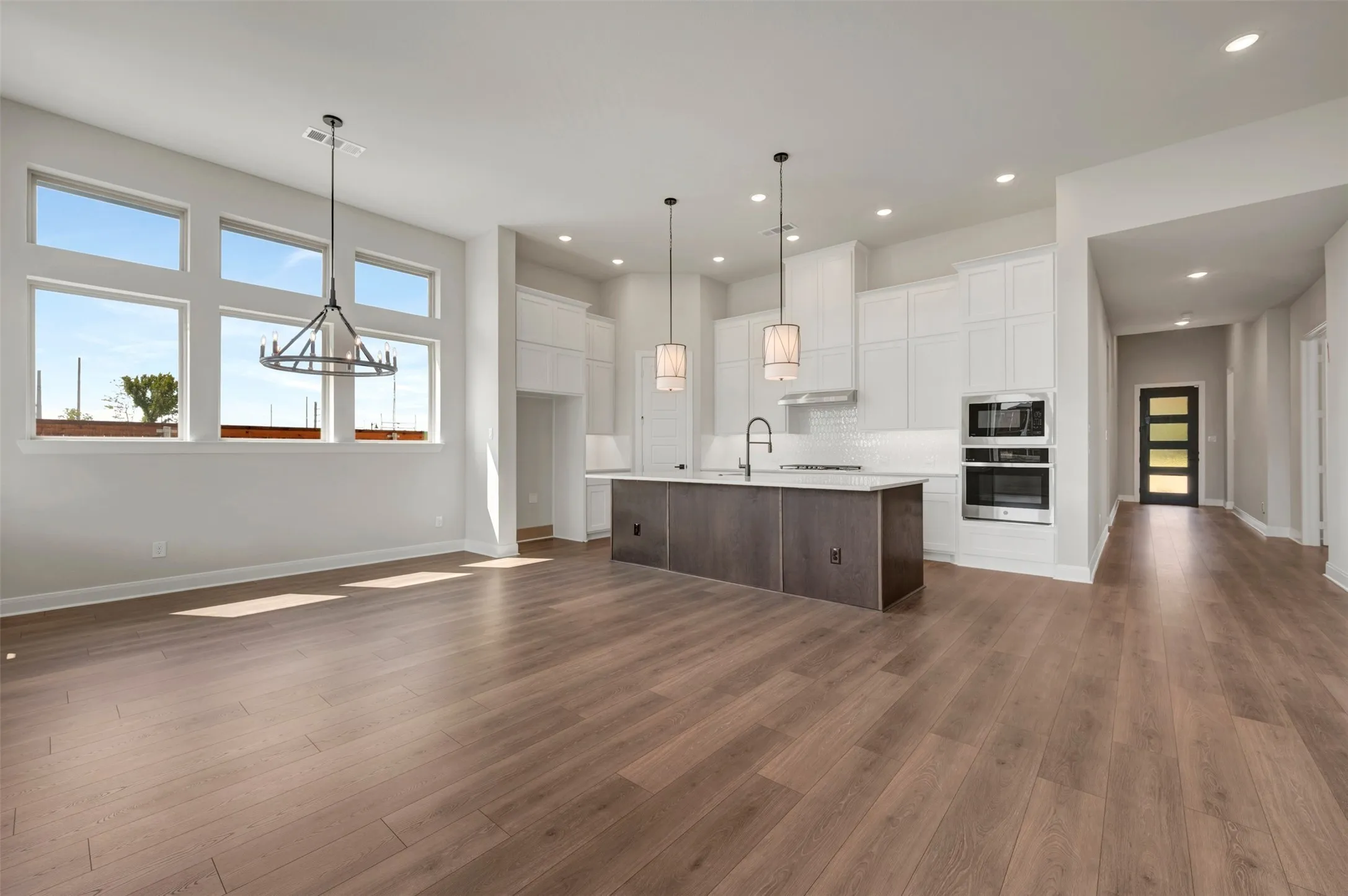 Spacious open-concept interior featuring wood-finish flooring throughout