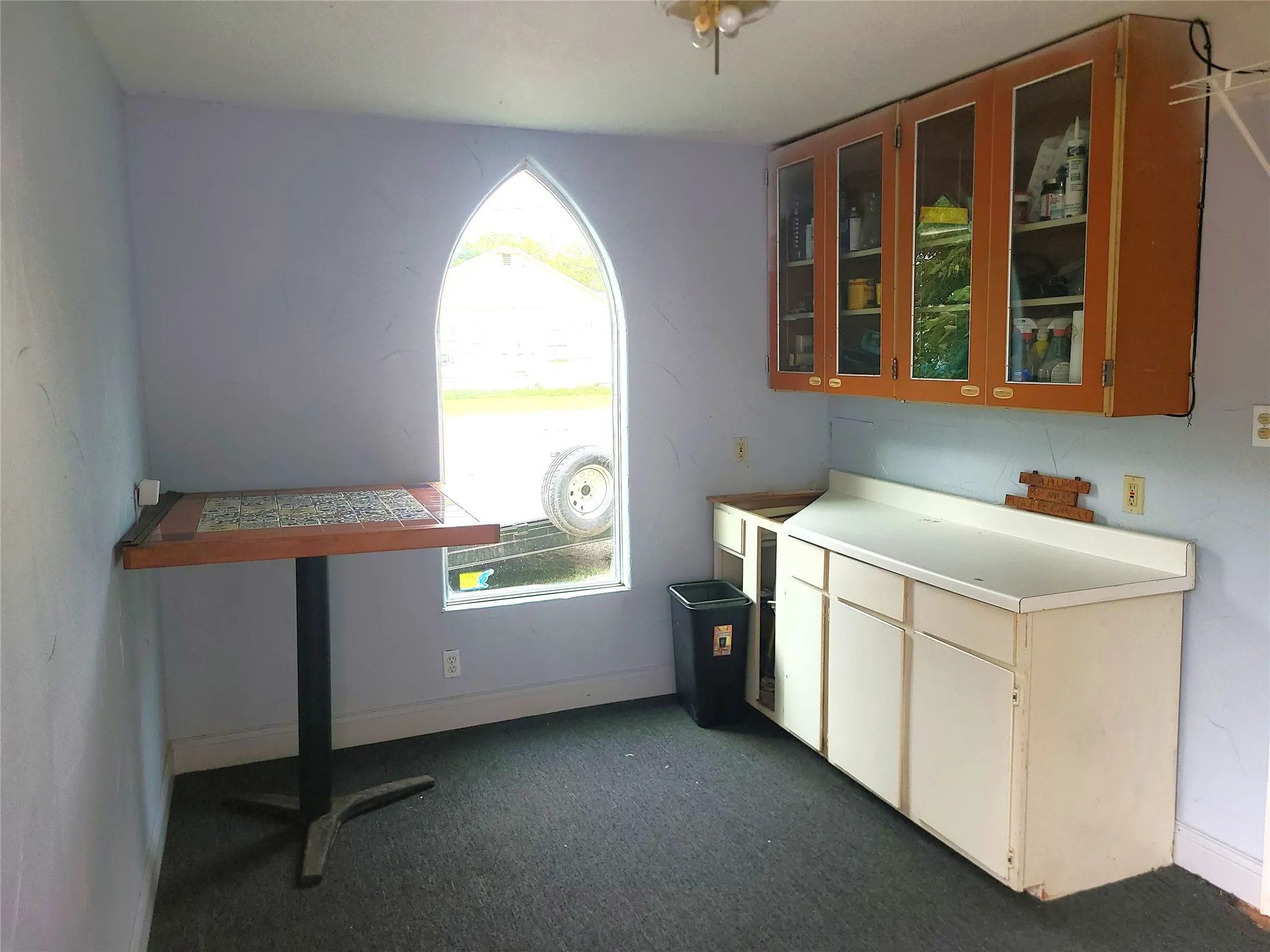 Kitchenette with glass front cabinets.
