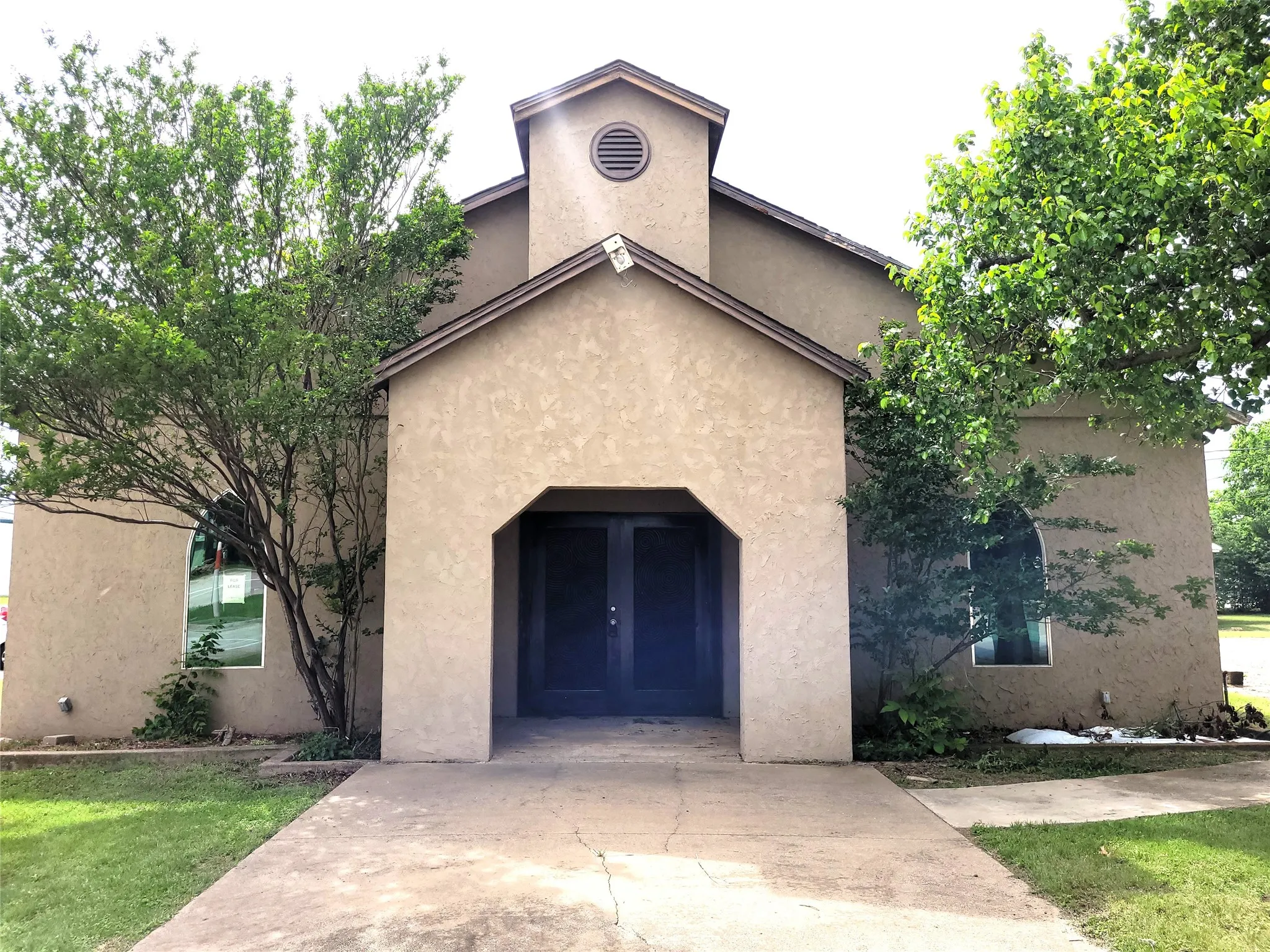 Large entryway with double doors. This has previously been a school, church, and insurance office.