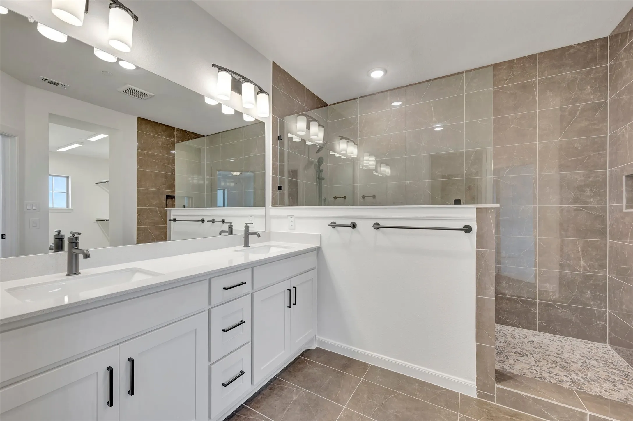 Double vanity featuring undermount sinks, contemporary faucets, and white shaker cabinetry