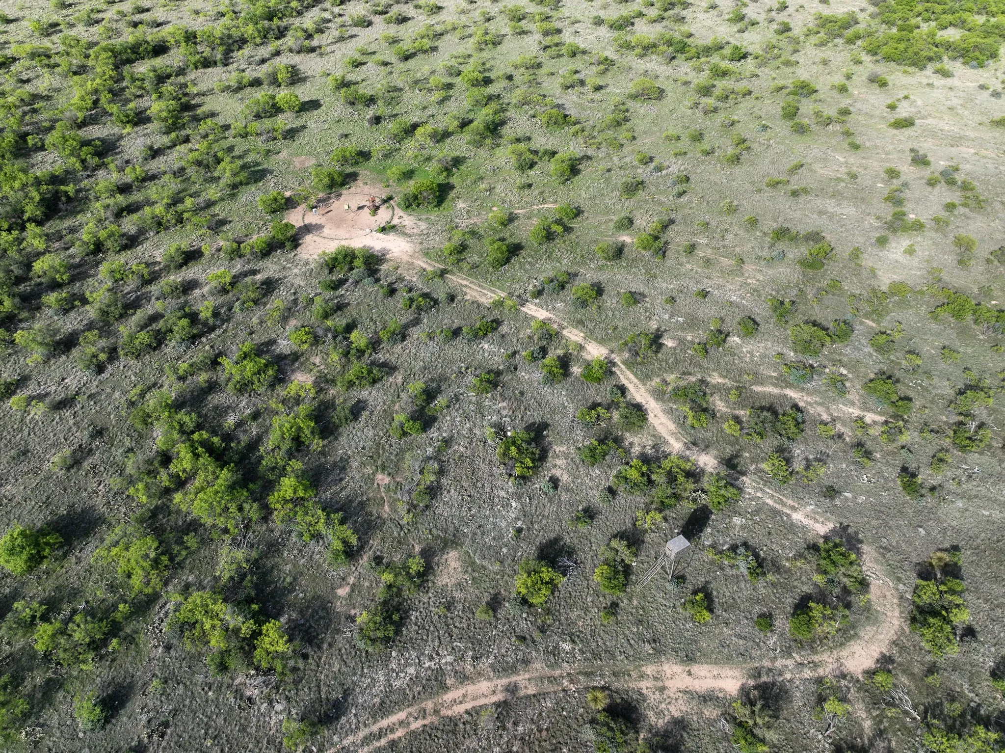 Extensive acreage with natural vegetation and visible dirt paths