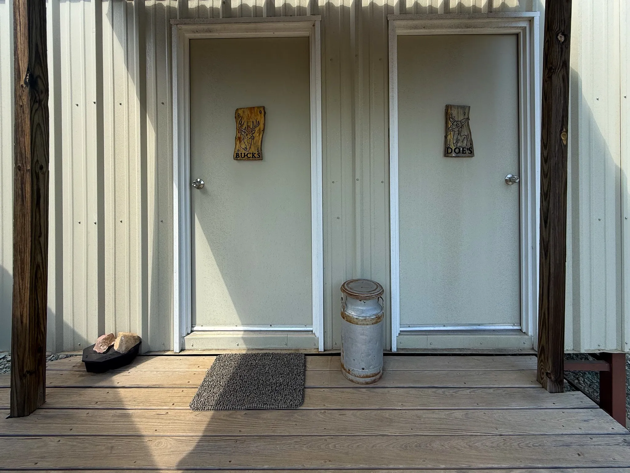 Two exterior doors set within a corrugated metal wall
