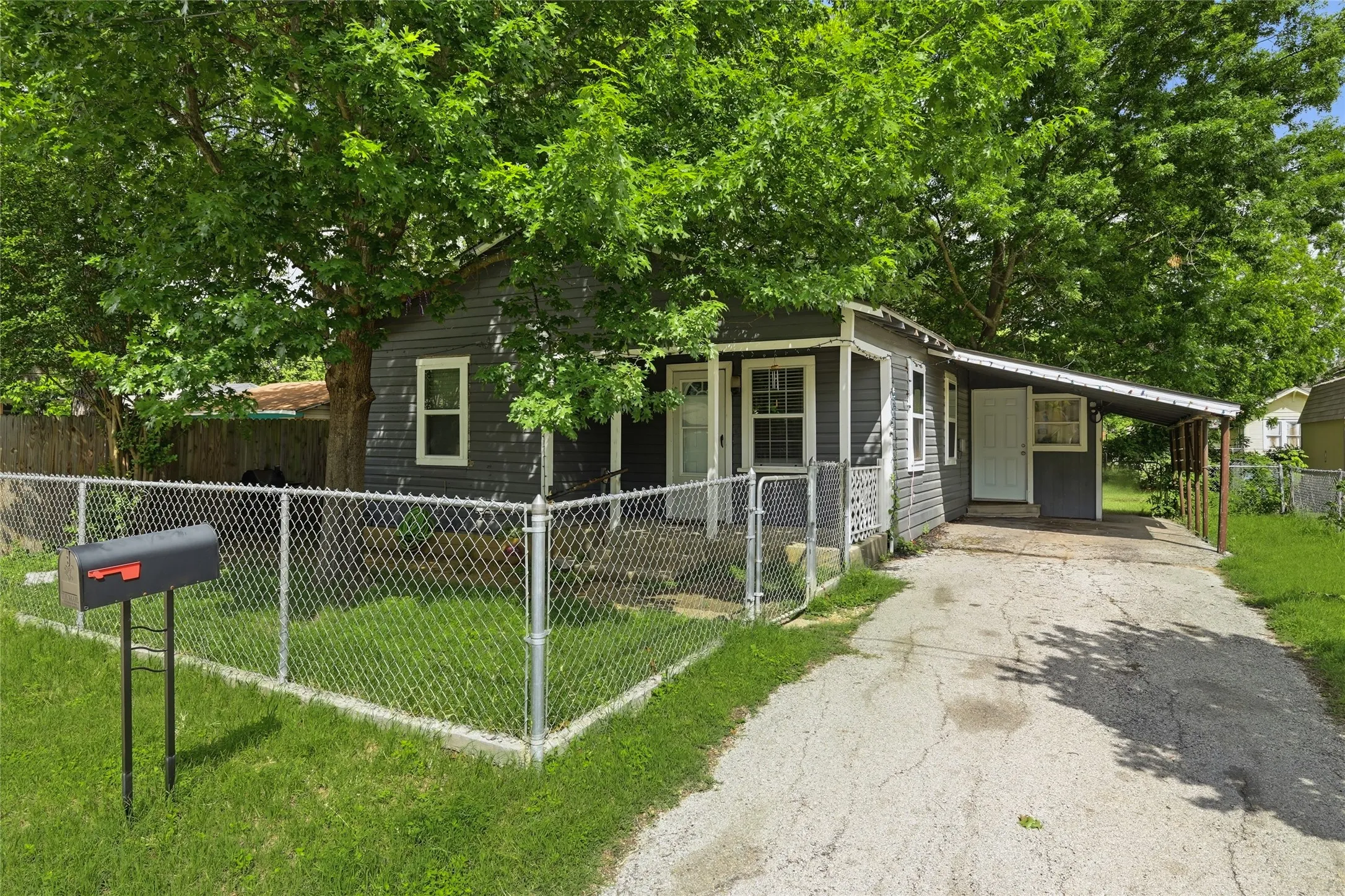 Front exterior with driveway and covered carport