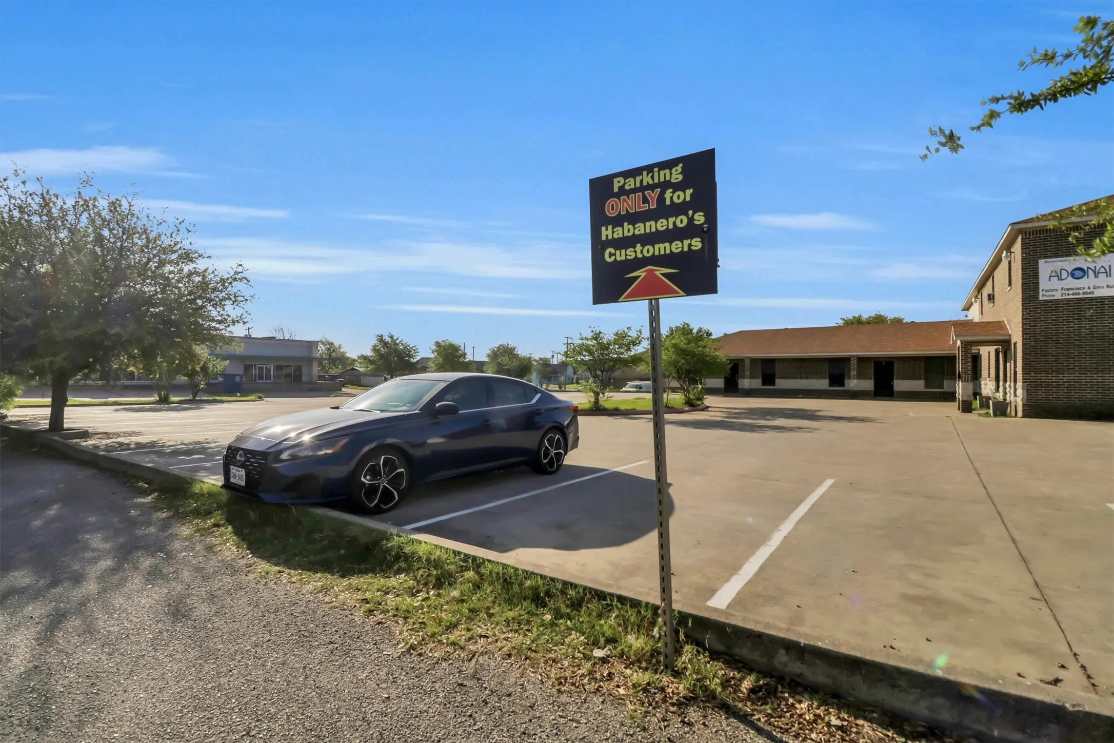 Expansive asphalt parking lot with painted parking lines
