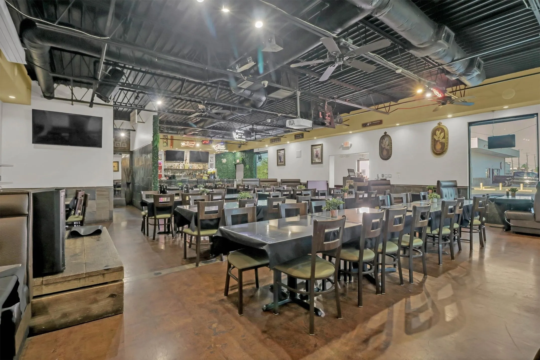 Spacious interior with exposed ductwork, recessed lighting, and ceiling fans