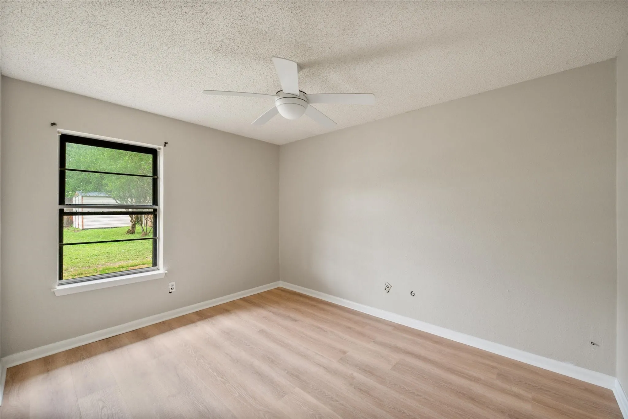 Neutral tone walls with wood-finish flooring