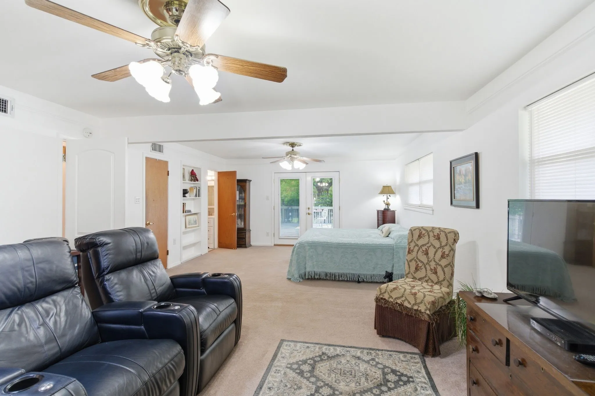Open-concept room featuring light beige carpeting and white painted walls
