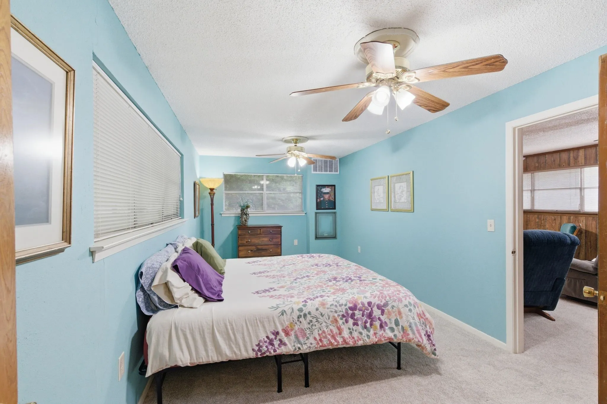 Wall-to-wall carpeting and multiple ceiling fans with integrated lighting fixtures