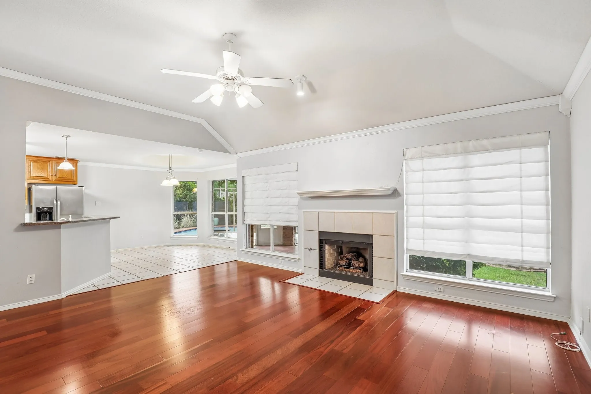 Vaulted ceilings featuring a white ceiling fan with integrated lighting