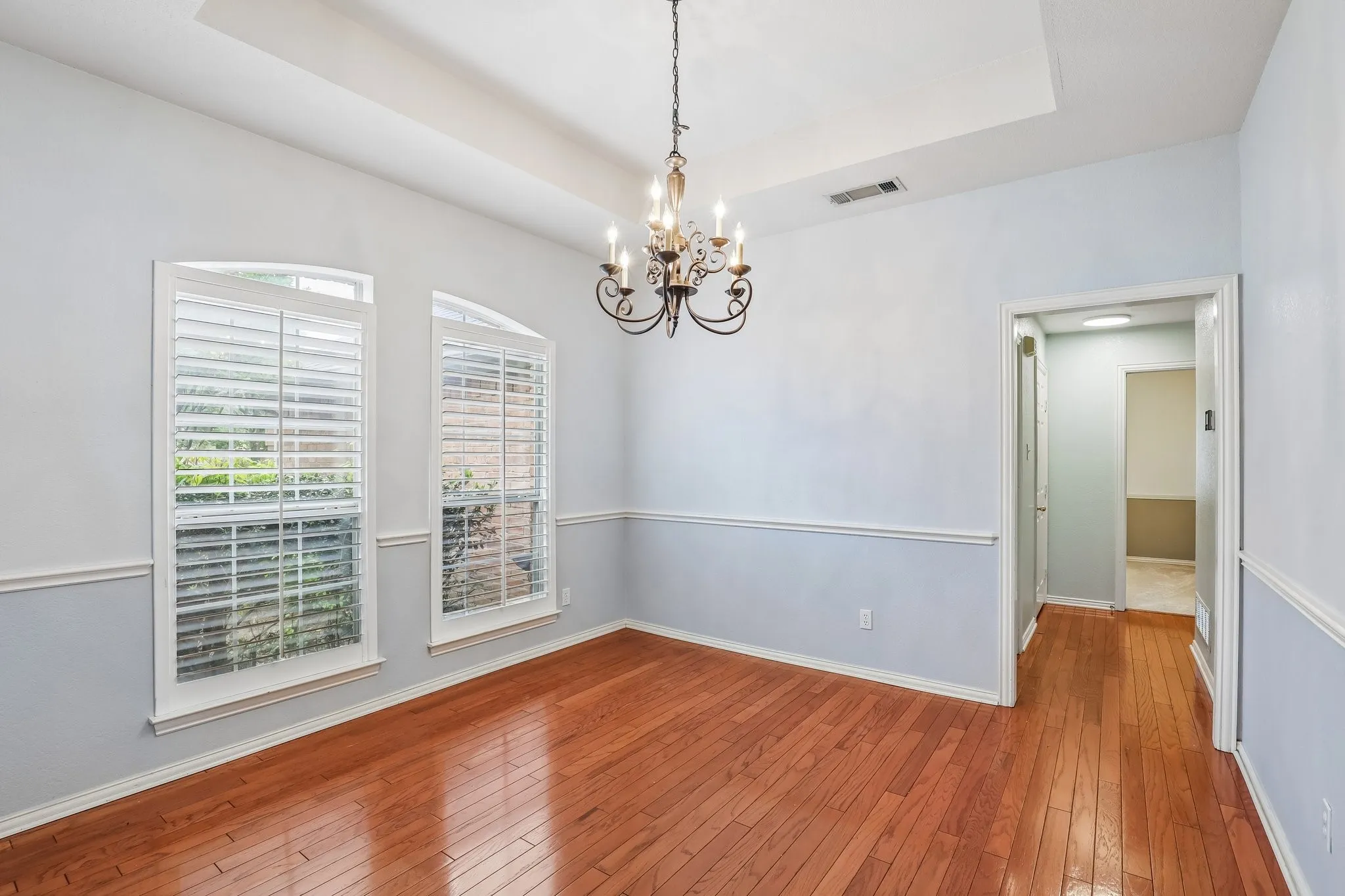Room featuring wood-finish flooring and a tray ceiling
