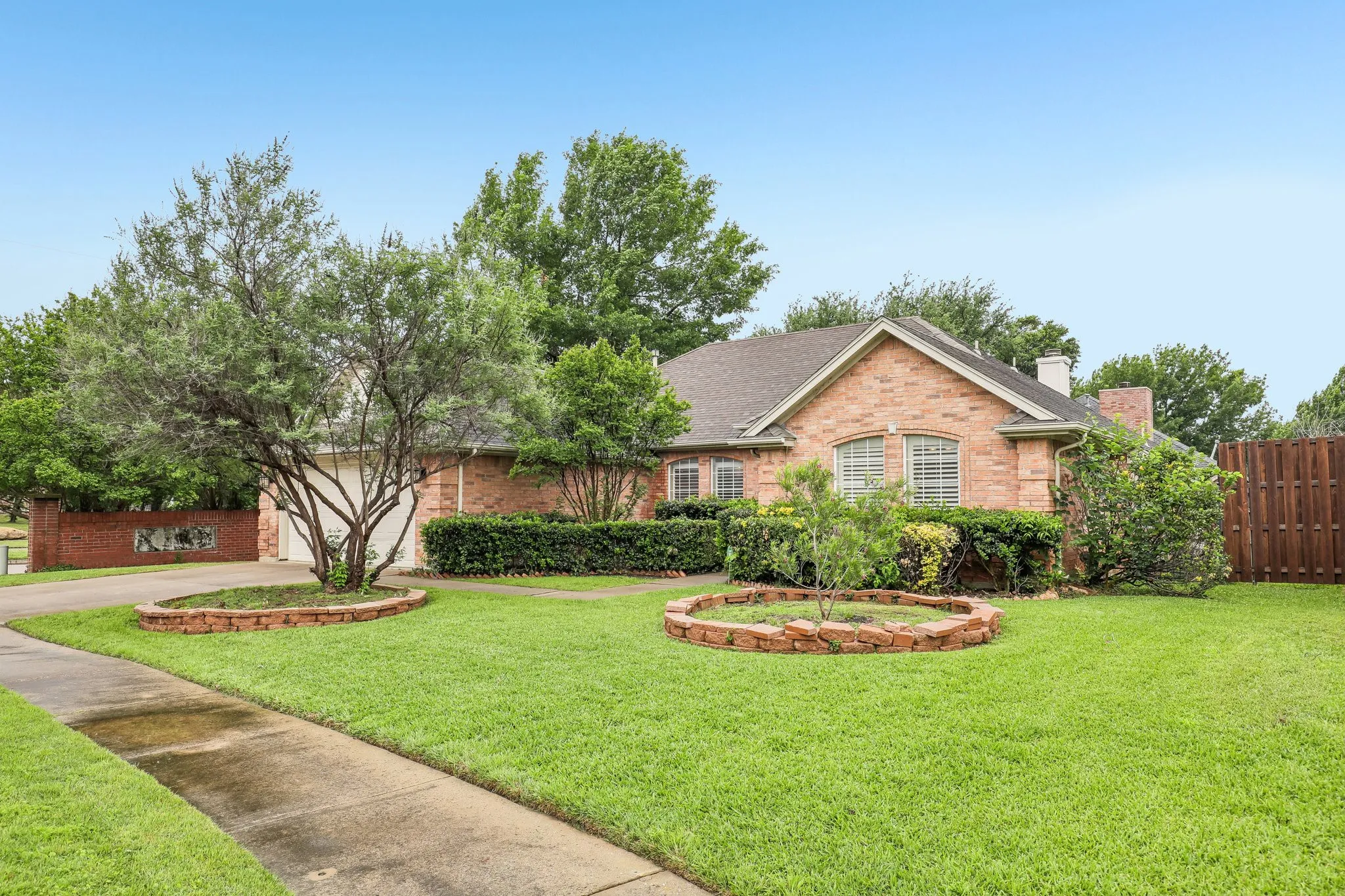 Brick exterior residence featuring a gabled roofline and multiple windows