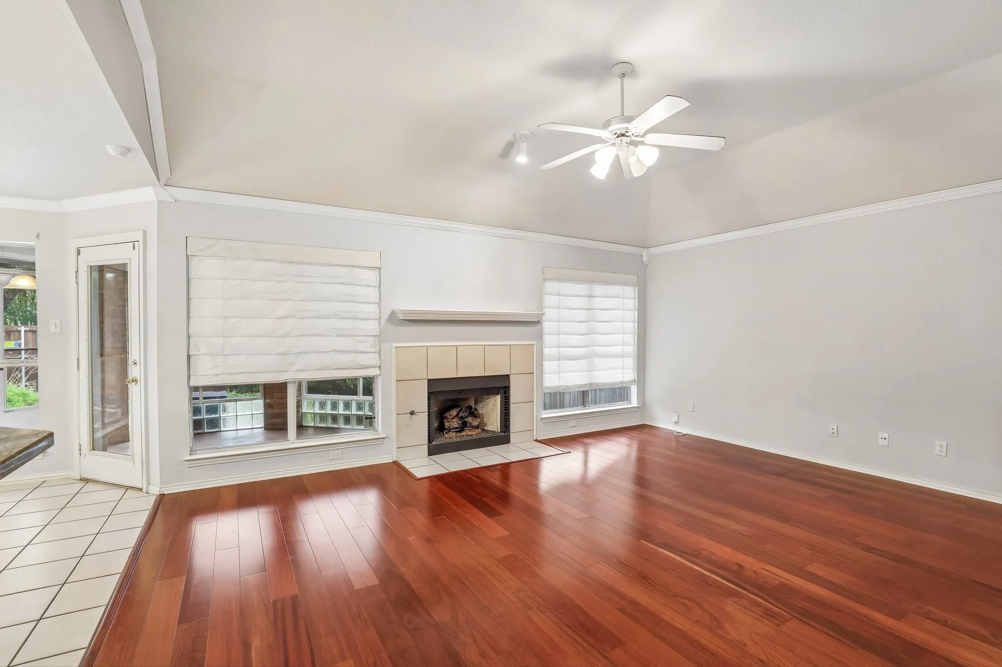Living area featuring rich wood-finish flooring and a vaulted ceiling