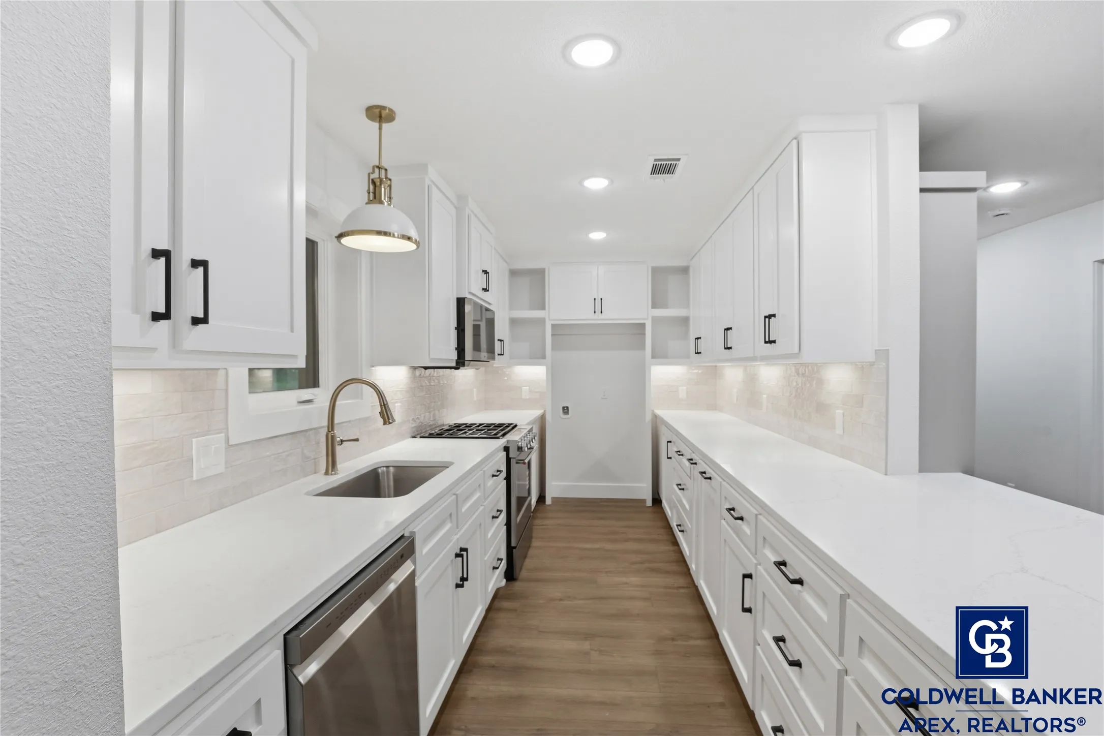 The gourmet kitchen is a showstopper, featuring stunning quartz countertops, gas cooktop, all new stainless steel appliances, and a spacious layout that flows seamlessly into the breakfast area and living area.