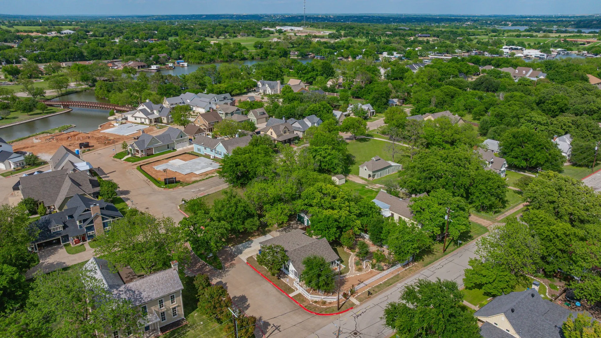 Aerial perspective showcasing a residential community with abundant mature trees and homes with varied architectural styles
