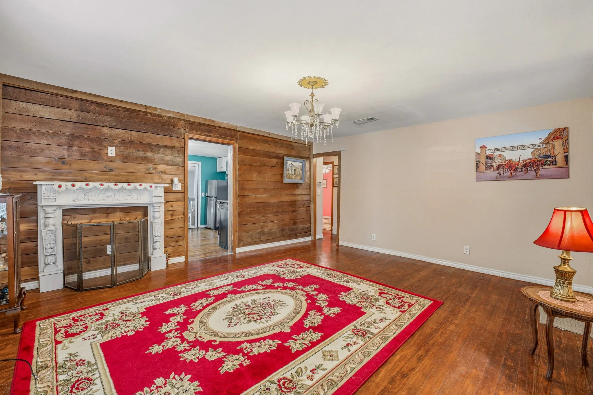 Expansive room featuring wood-finish flooring and a distinctive wood-paneled accent wall