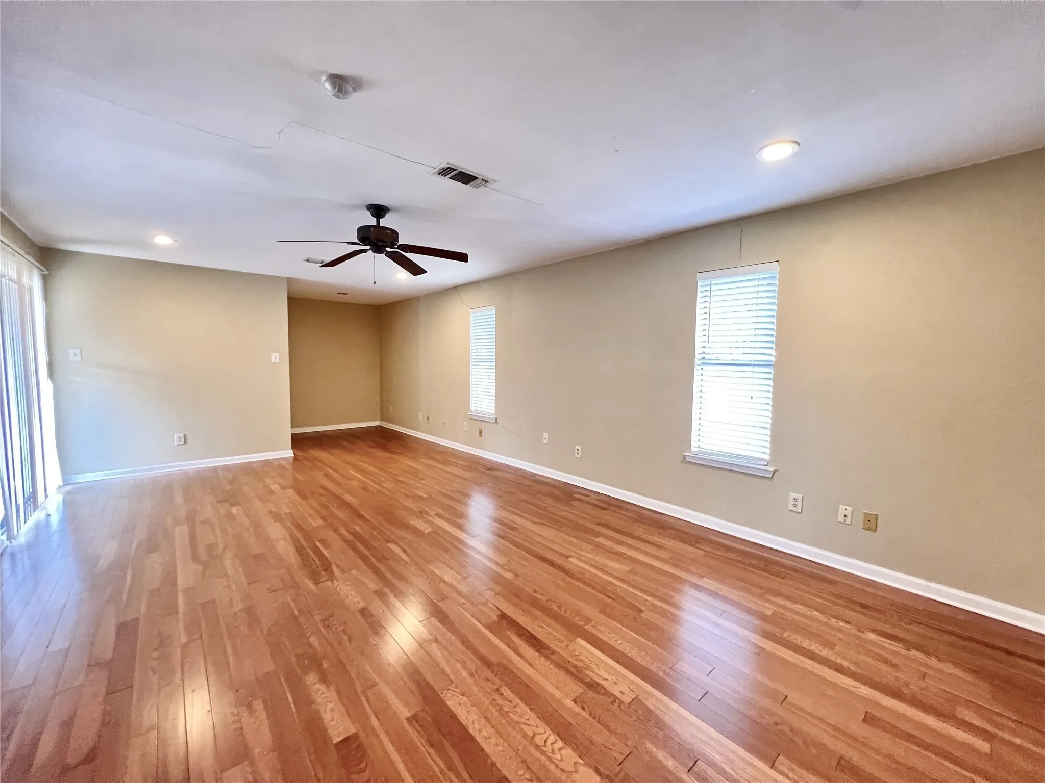 Hardwood flooring throughout, recessed lighting, ceiling fan, and window blinds. These pictures are prior to the current tenant moving in.