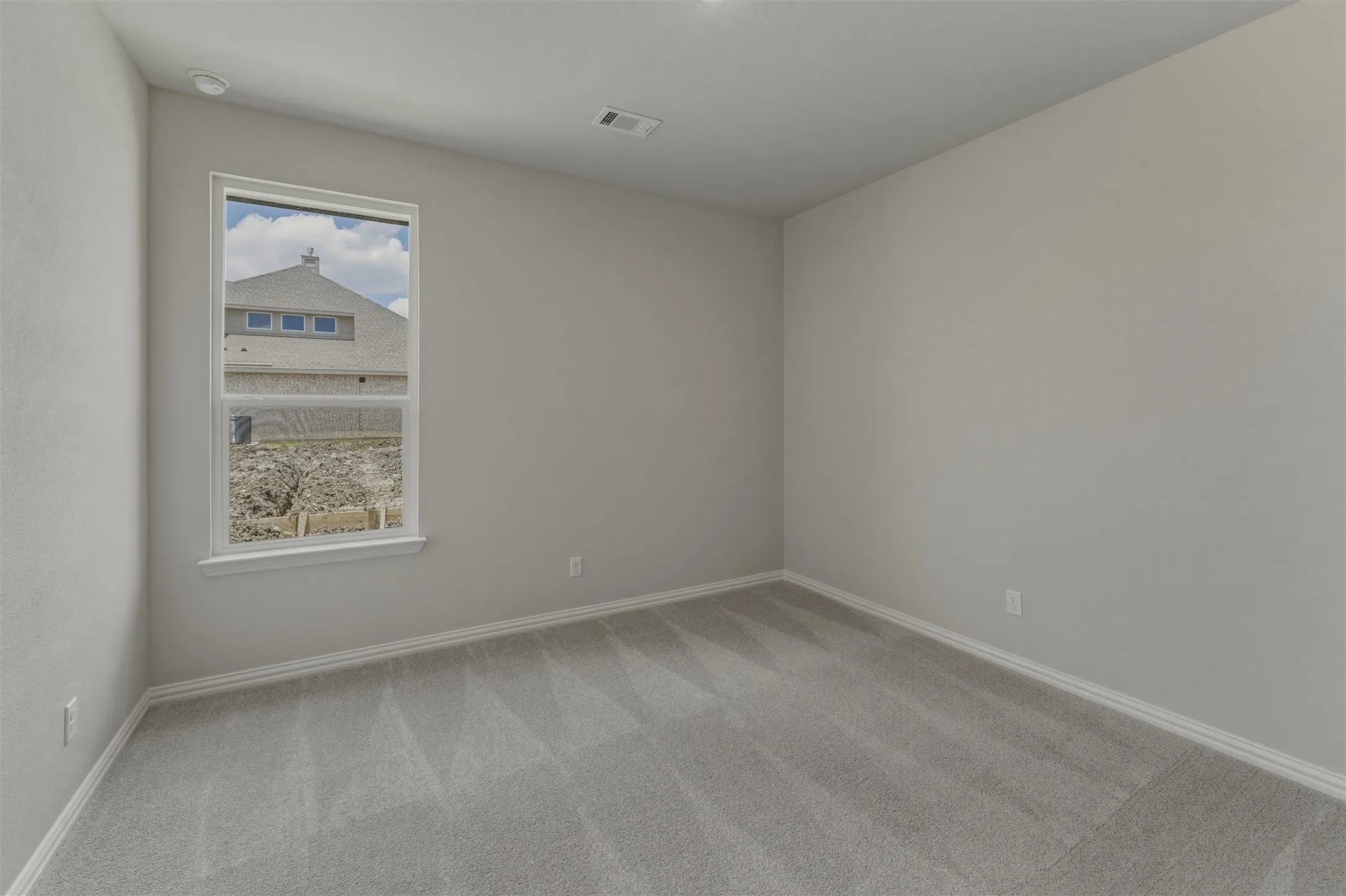 Room featuring light gray carpet, white baseboards, and neutral wall paint