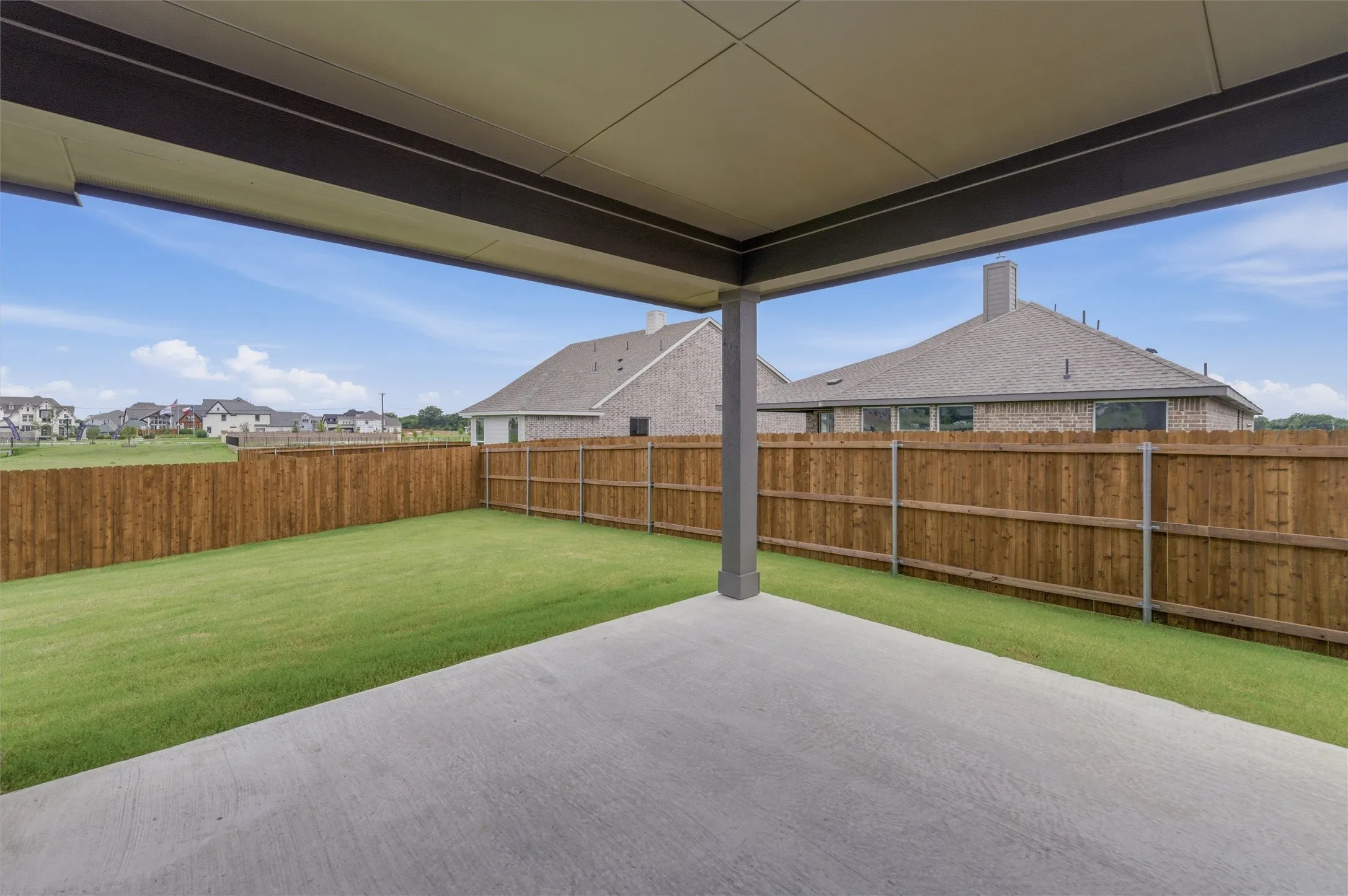 Covered patio featuring a concrete slab and a single support pillar