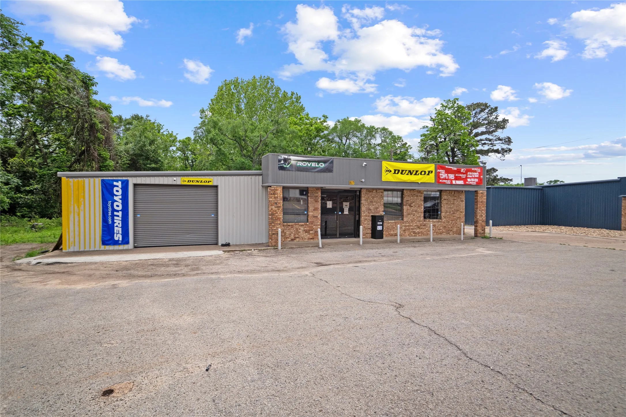 Commercial building featuring a brick facade with multiple window openings and a prominent storefront entrance