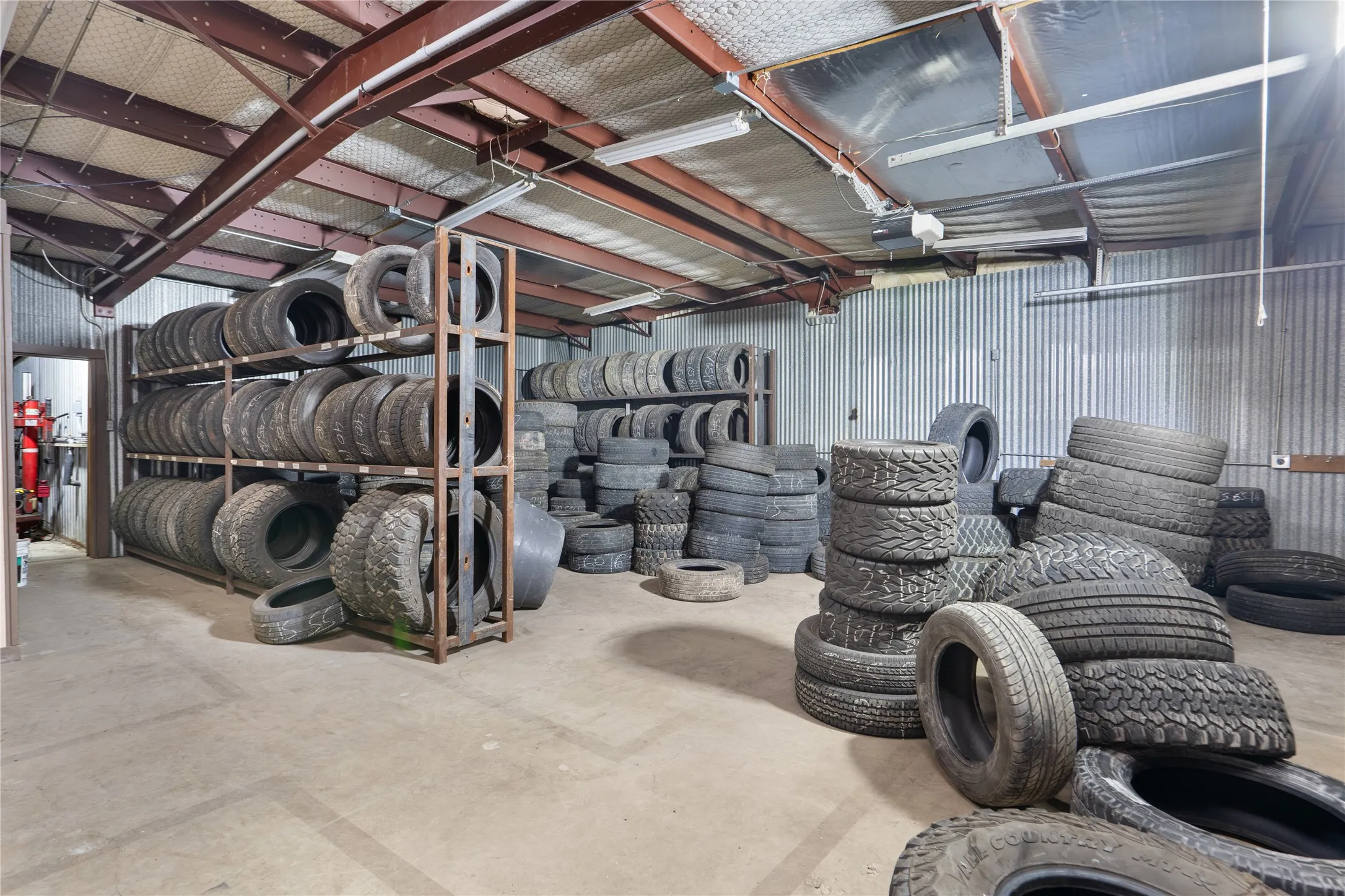Spacious industrial interior featuring corrugated metal walls and concrete flooring