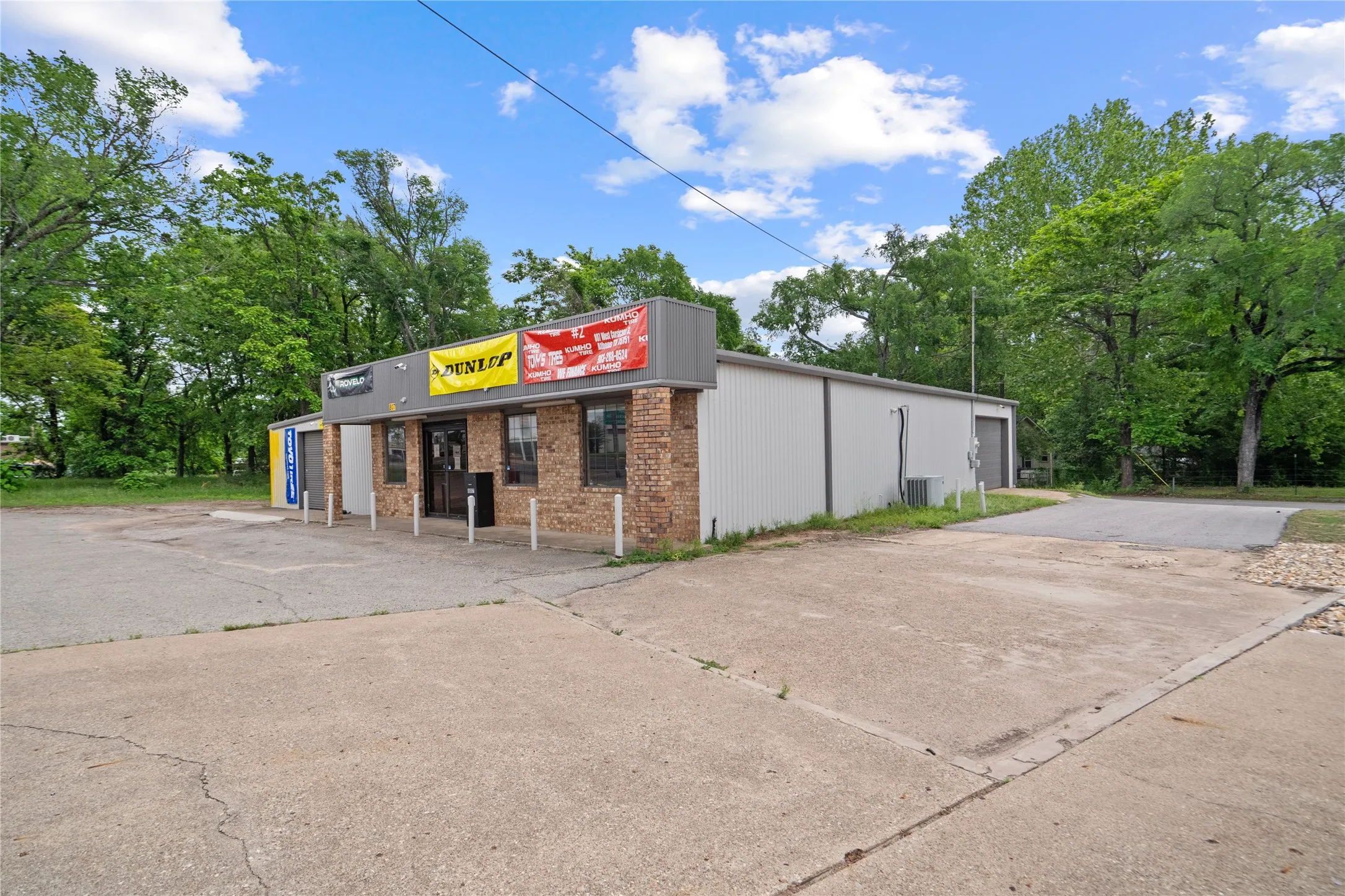 Commercial building featuring a brick facade and corrugated metal siding