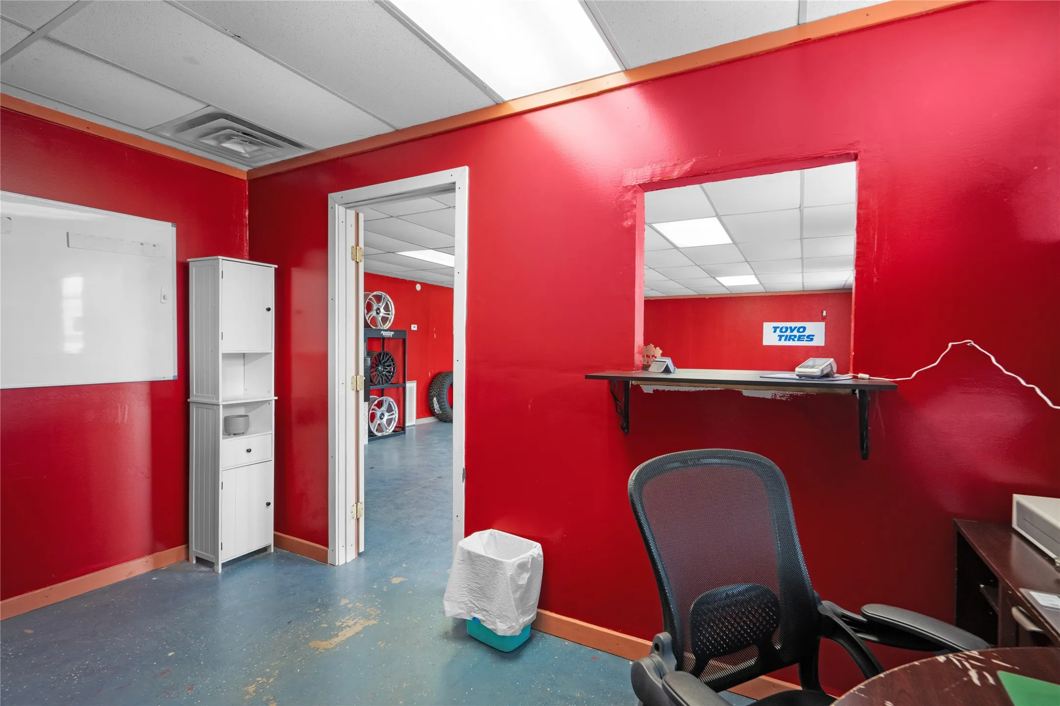 Commercial space featuring vibrant red walls and blue flooring