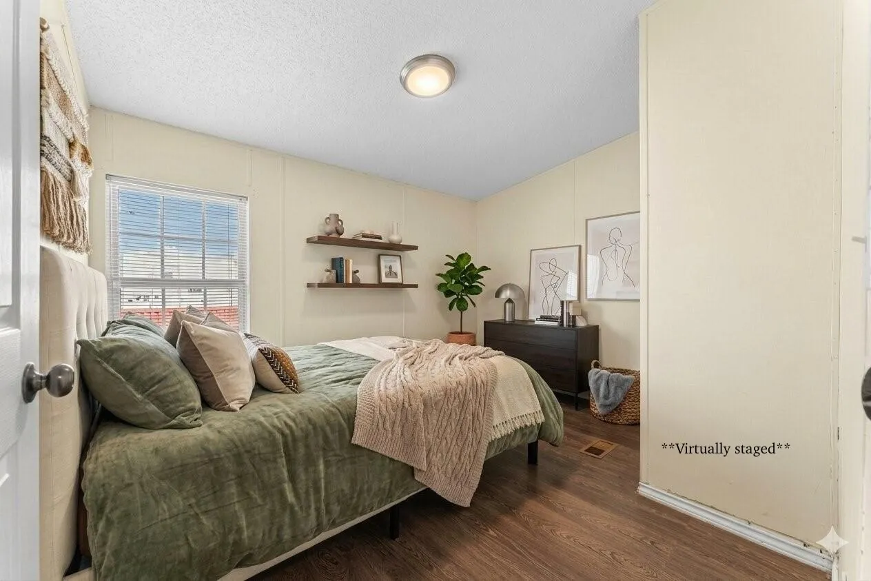 Wood-finish flooring with a window featuring blinds