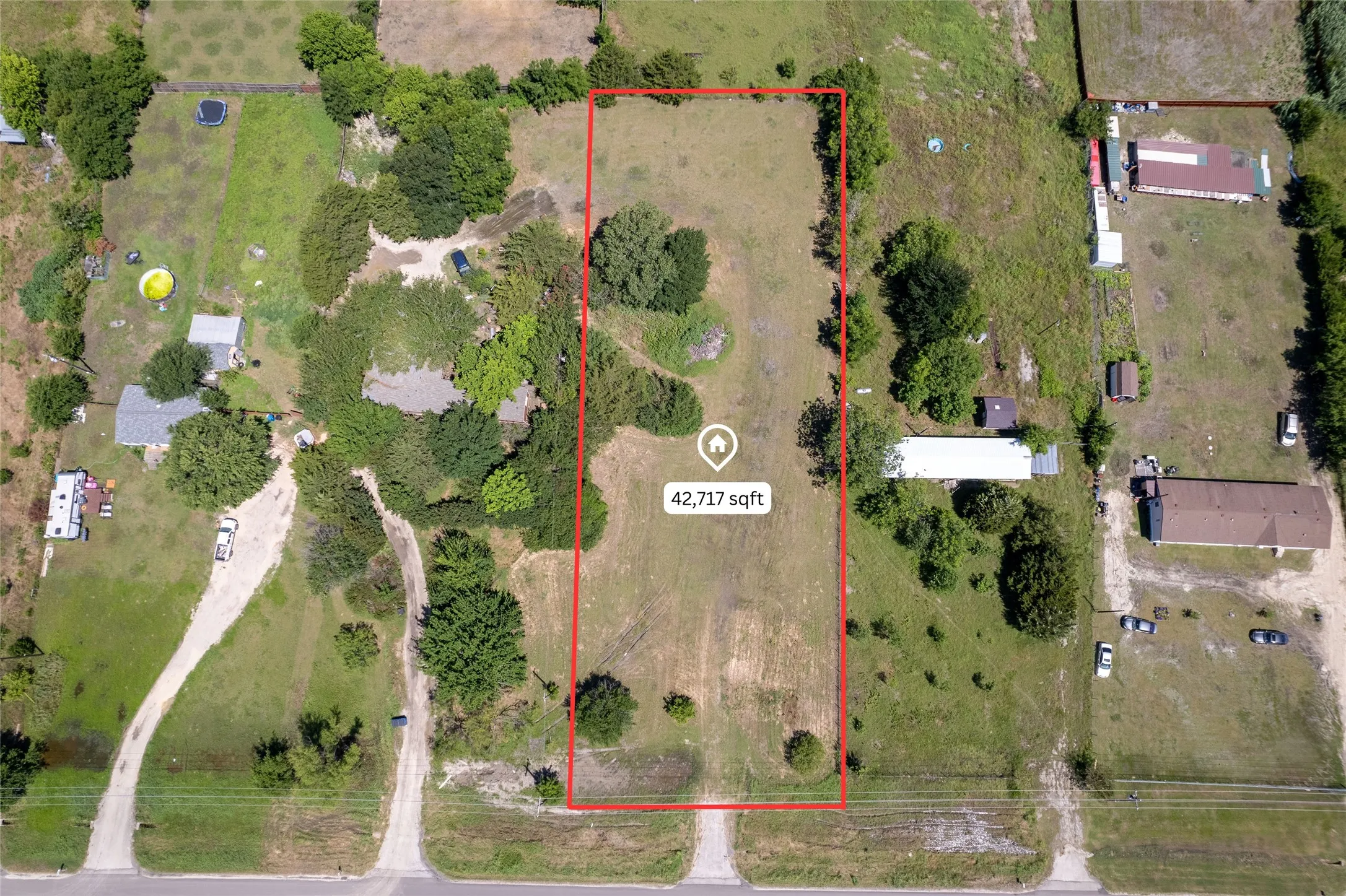 Expansive 42,717 sq ft parcel featuring a mix of cleared land and mature trees