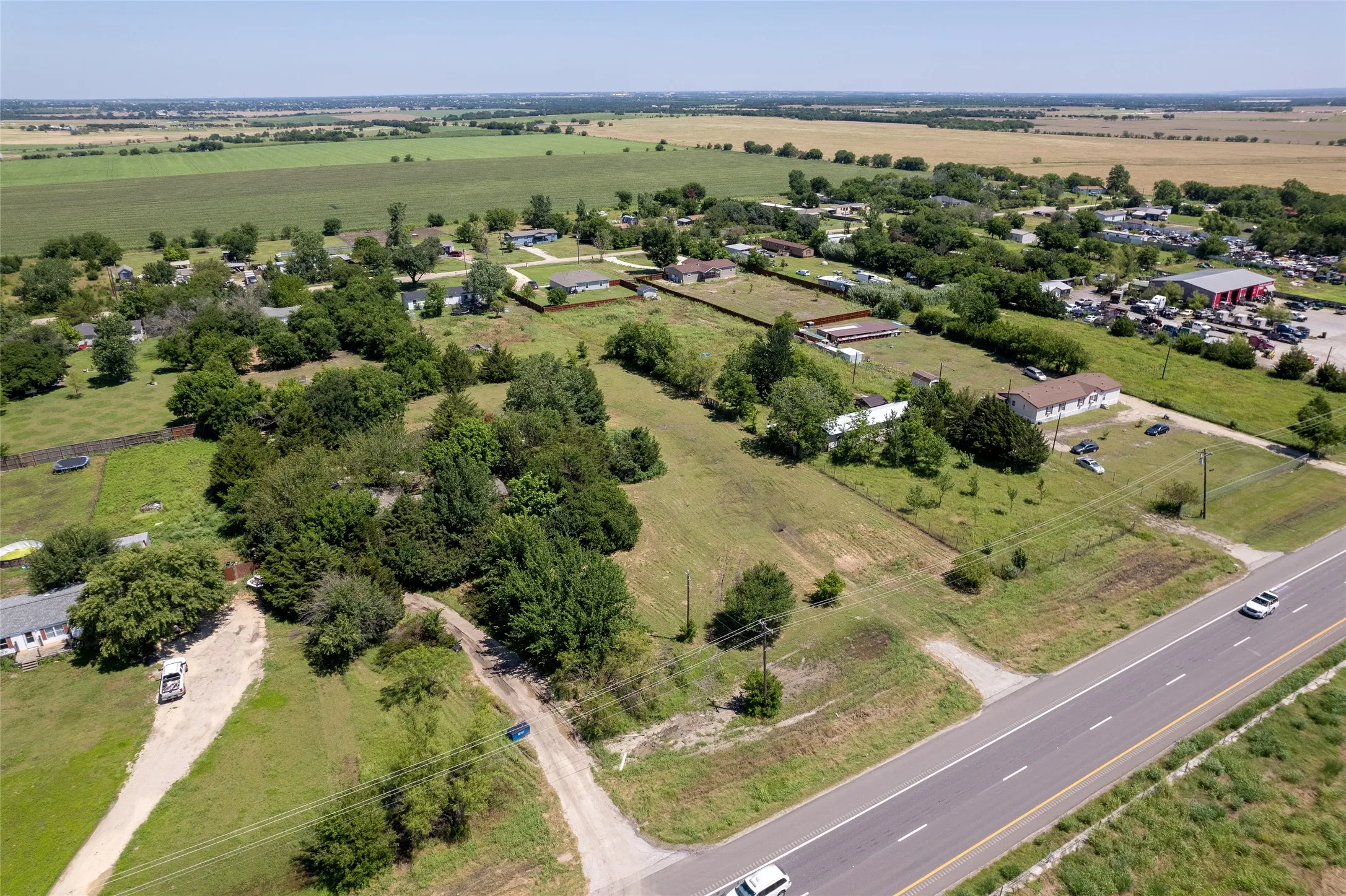 Expansive property featuring undeveloped land and existing structures